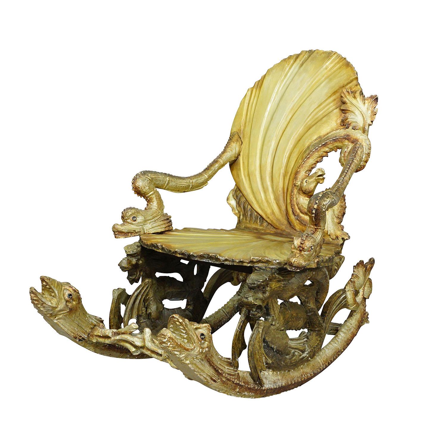 An antique handcarved Venetian rocking chair in grotto design. Seat and backrest in the shape of sea shells, backrest supported by a sea horse. The base features fish heads and sea snakes on booth sides. Executed by Pauly et Cie, Venice, Italy ca.