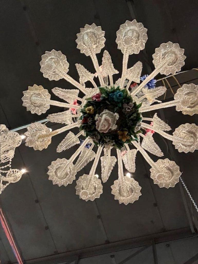 The Antique Venetian Chandelier with Flowers is a true work of art. With its intricate design and eye-catching floral elements and clear glass leaves, this chandelier adds a touch of elegance and charm to any room. This lighting fixture is sure to