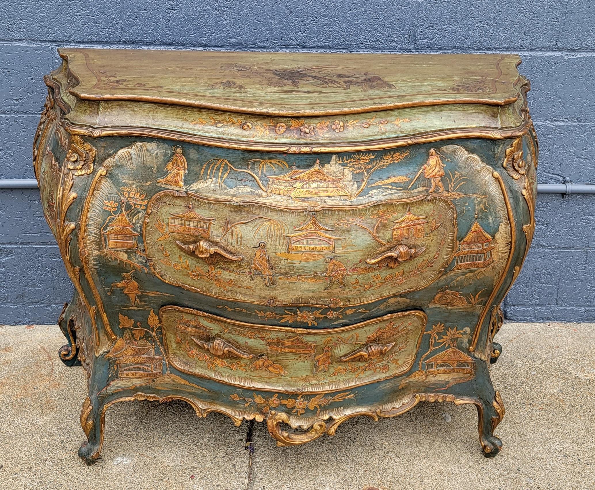 18th century Italian commode embellished with hand lacquered chinoiserie detail. Over-exaggerated Bombe form with warm blue, green and gold tones. Retains original 18th century chinoiserie lacquer decoration and original carcass. As this piece has