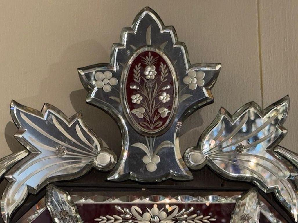 Antique Venetian mirror with etched design and red glass.  Featuring a really pretty floral design. Makes an impressive impact.  A true work of art!  Circa 1920
21w x 37h