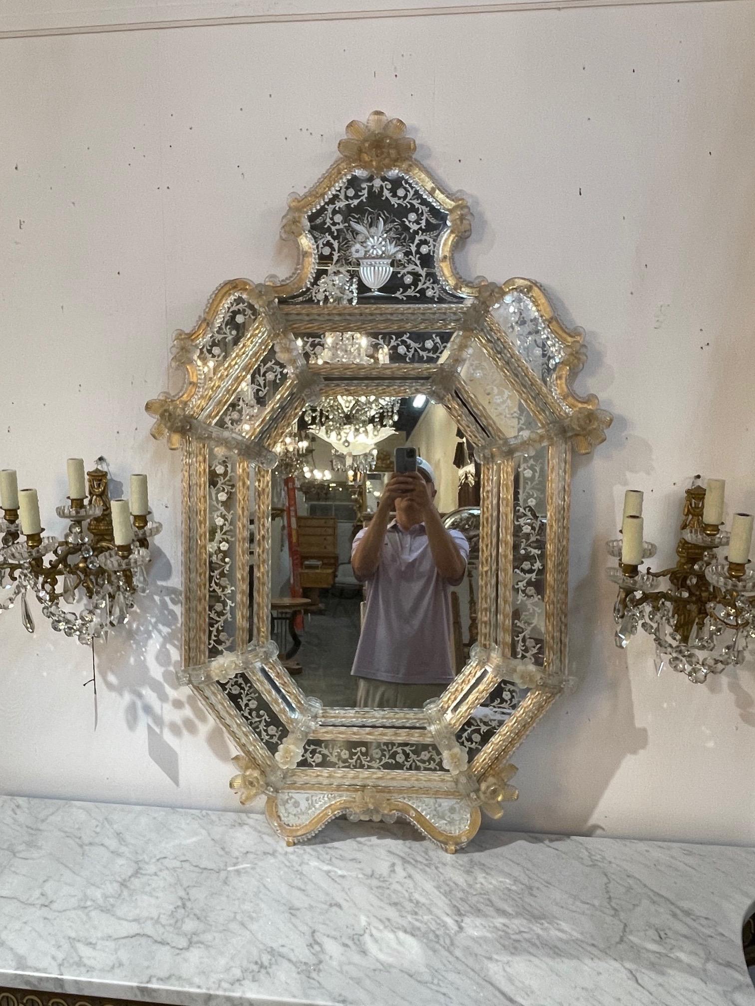 Beautiful early 20th century antique Venetian etched glass mirror. Lovely images including leaves, flowers and a vase on the mirror along with pretty gold and white decorative venetian glass on the border. A classic piece!! And in great condition!