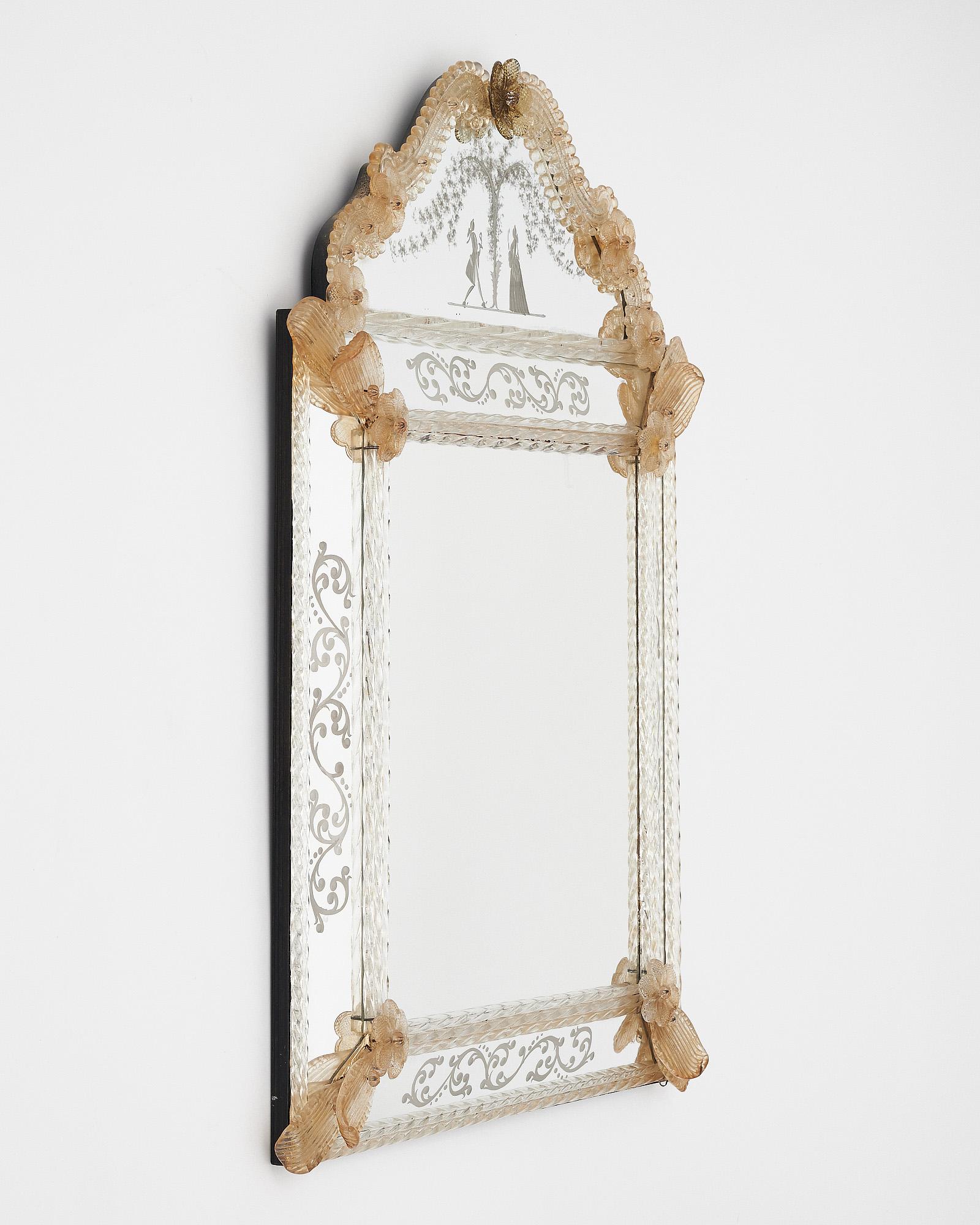 Venetian wall mirror featuring a central rectangular mirror with fronton, floral motifs, and torsadoes. Floral friezes frame the mirror and the fronton shows an engraved romantic scene. This piece is in beautiful condition.
