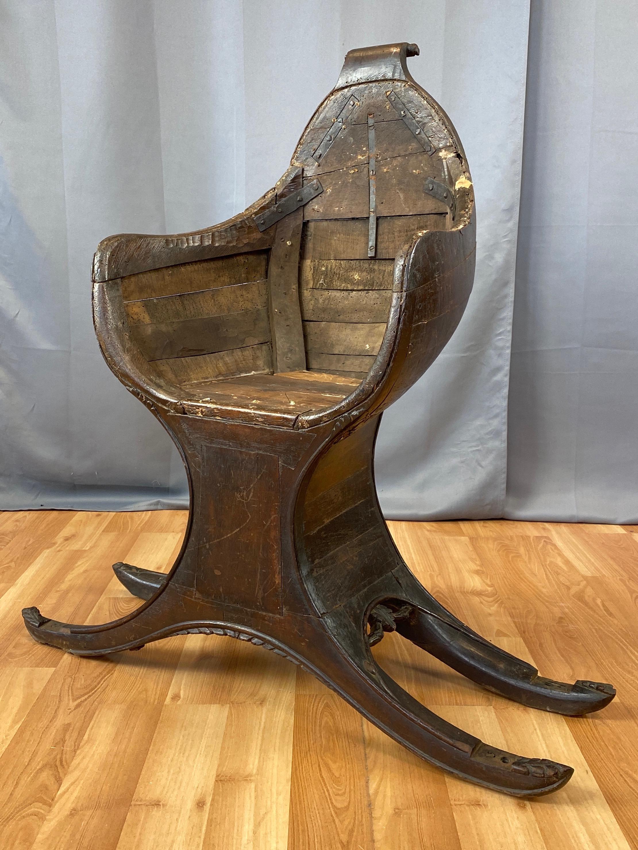An authentic 18th century Venetian gondola chair displaying great classical form, understated embellishments, and handsome antique character.

Hand-crafted of solid walnut with a dark brown finish that’s acquired a rich patina. Curvaceous lines