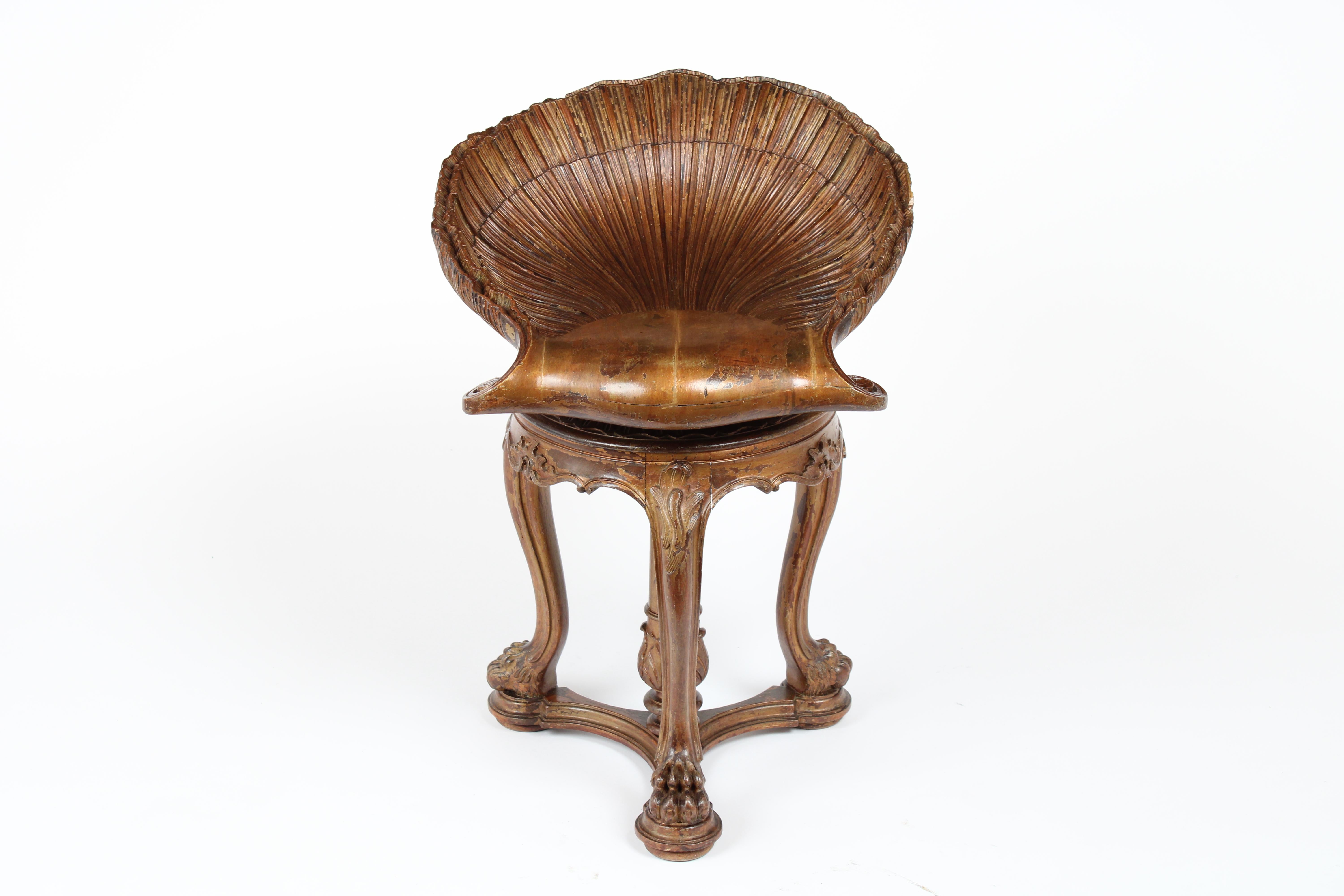 Unique Venetian late 19th century Grotto style piano stool is made out walnut wood this bench feature an incredible hand carved shell design adjustable seat, this stool is very sturdy with the stretch pedestal finishes with carved claw feets details.