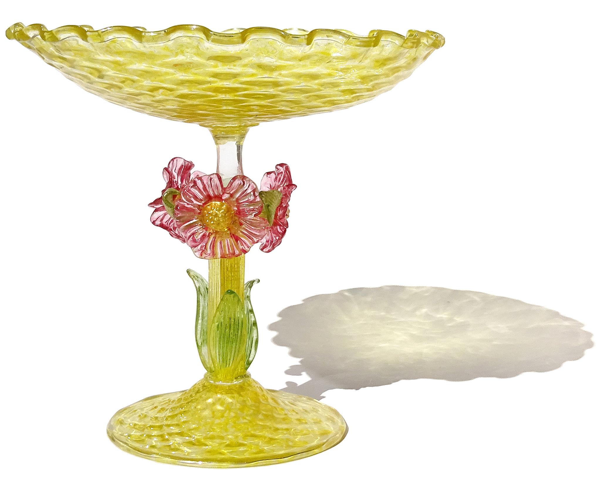 Gorgeous, large antique Venetian hand blown yellow quilted surface Italian art glass footed tazza / compote bowl. The piece is created in the manner of the Italian companies Salviati and Fratelli Toso, circa 1900s. The stem of the bowl has 3 large