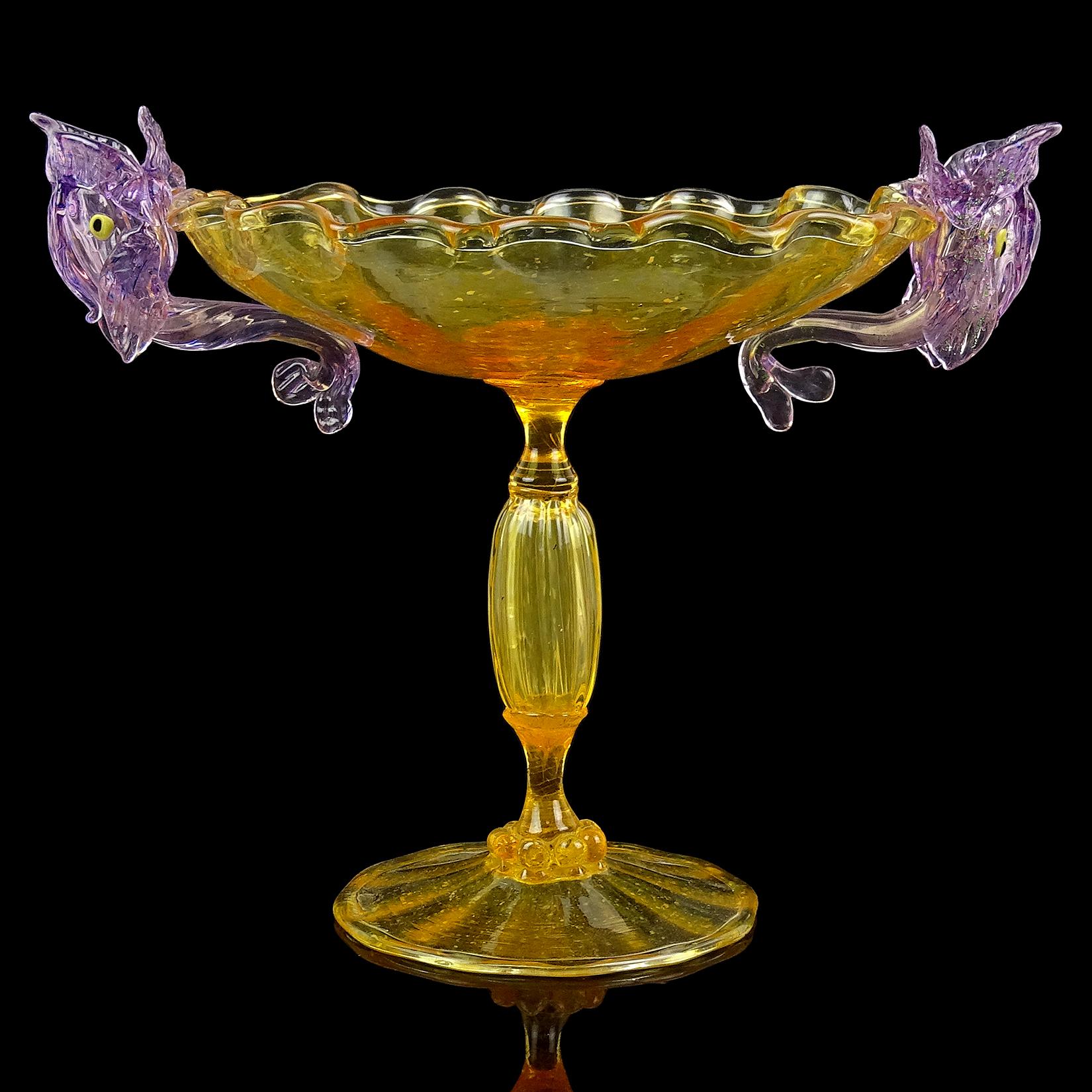Beautiful, antique, early Venetian / Murano hand blown orange Italian art glass tall footed compote bowl / candleholder with applied purple fish decoration. Created in the manner of the Salviati and Fratelli Toso companies. The color within the