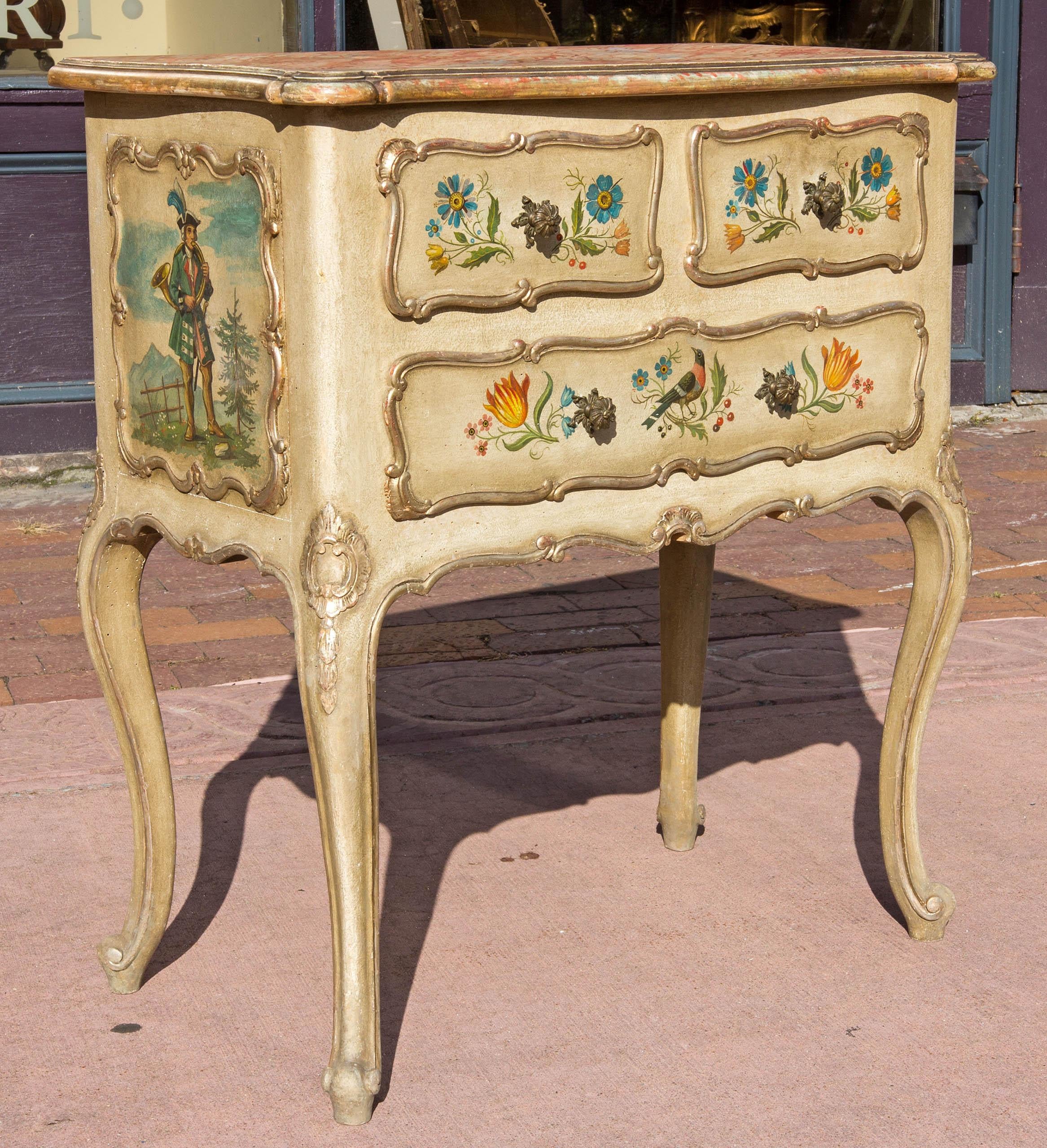 Petite Venetian painted three-drawer commode. Well painted with birds, flowers, female falconer and male musician. Gilt trim. Marbleized top, circa 1900. Please, contact us for shipping options.