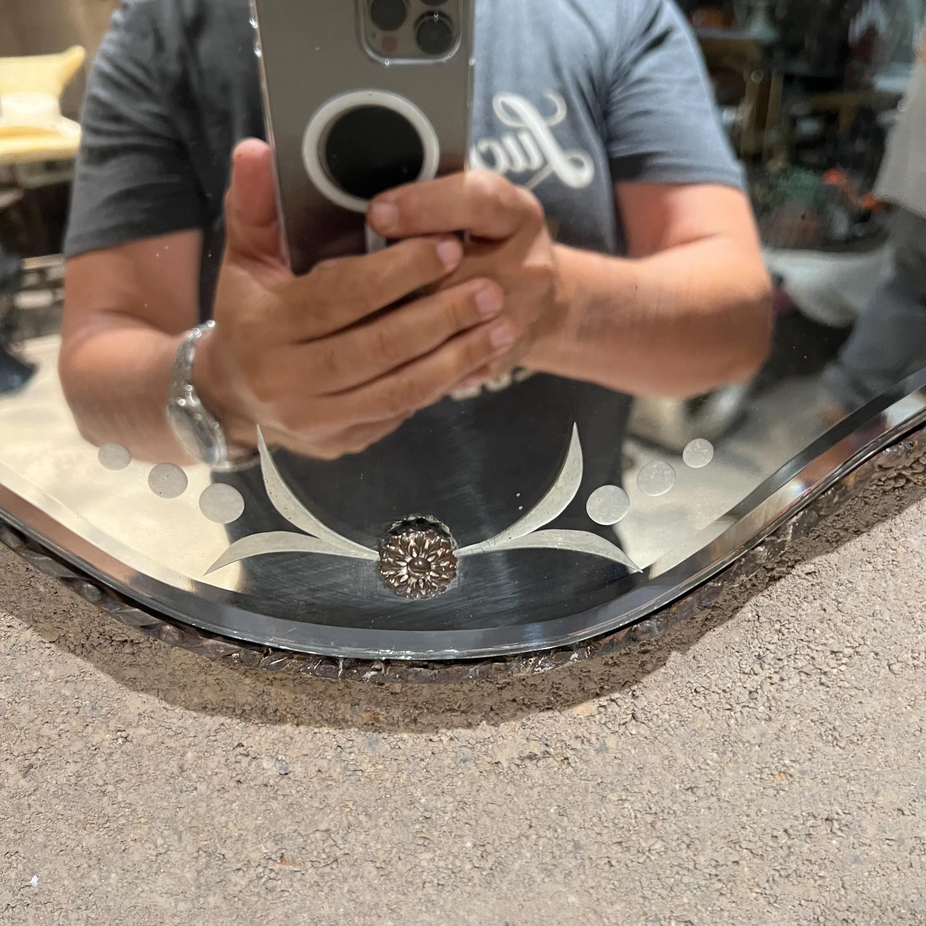 Italian Antique Venetian Wall Mirror Ornately Carved 
Etched Glass Floral Design
Sculptural shield design
Features medallions on glass. Gold Gilt on Wood
31 tall x 17 w x 1.25 d
Preowned original unrestored vintage condition.
Please review images
