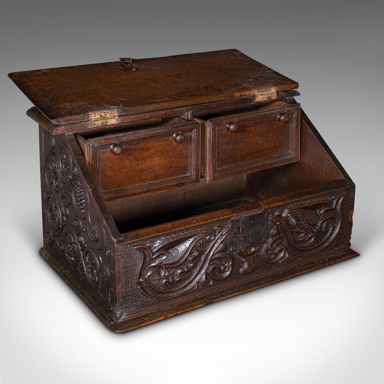 
This is an antique verger's bible box. An English, oak carved ecclesiastical case, dating to the William III period, circa 1700.

Fascinating carved box, with country provincial craftsmanship
Displays a desirable aged patina and in original