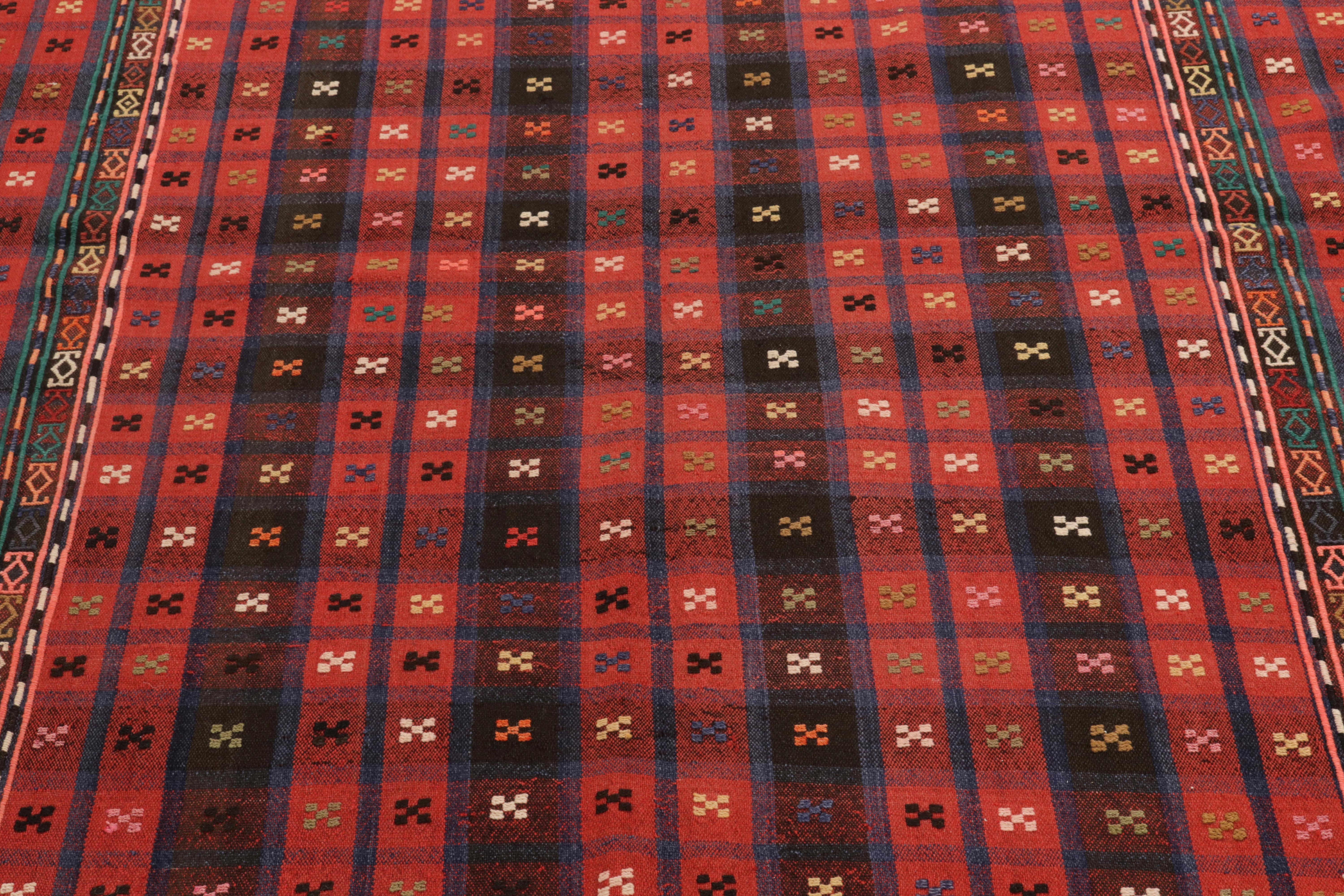 Handwoven in wool from Russia originating between 1880-1890, a 6x9 antique Verneh kilim enjoying a union of tasteful geometry & impeccable artistic interpretations. The selection of classic red & black tones in juxtaposition with blue, peach & green