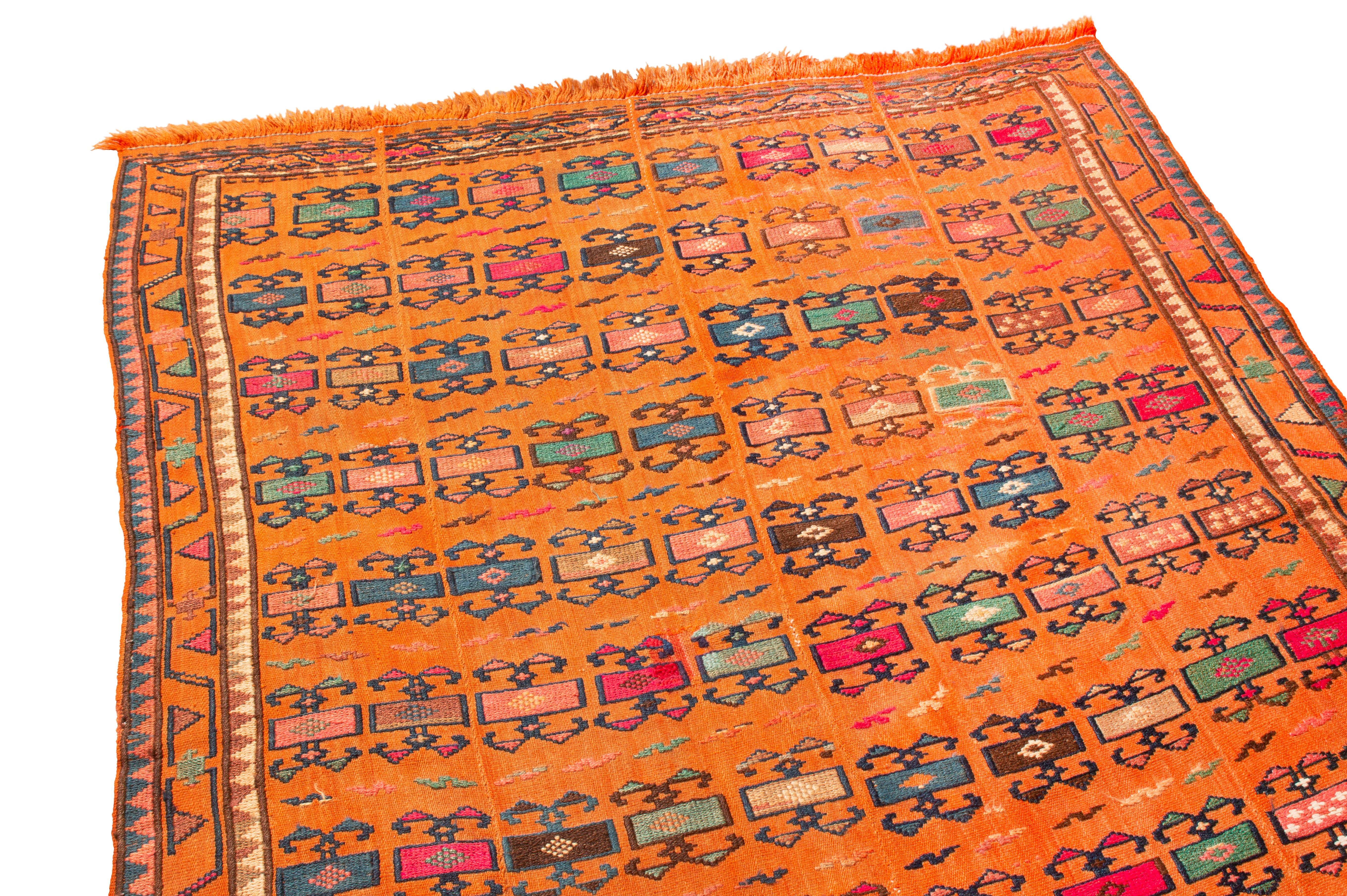 Originating from Persian in 1900, this turn of the century Persian wool kilim rug, a group of antique Cacasian kilims created up to the mid-20thcentury. Verneh antiques were woven with the Soumak style, a tapestry and textile technique weaving