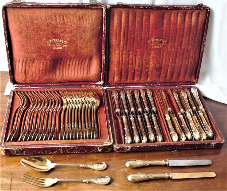 This set of antique French gold washed silverware were made by the well-known Veyrat company of Paris France, in circa 1890 in the period Art Nouveau style. There are a combined forty-eight pieces contained in these two leather fitted cases which