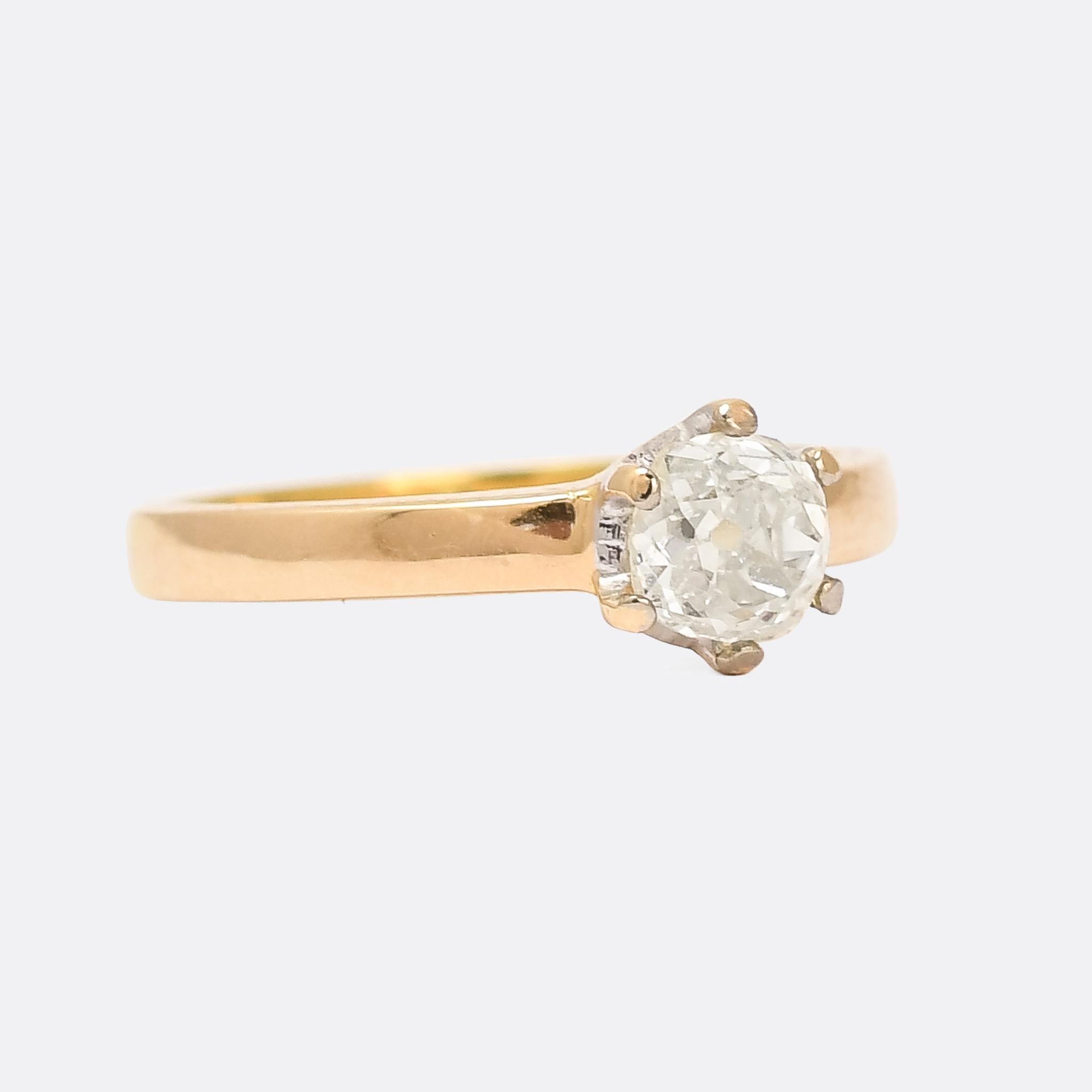 A simple claw-set diamond solitaire engagement ring set with the most gorgeous old mine cut diamond. The ring mount is minimal and perfectly proportioned, and, quite unusually, the inside of the claws and basket are finished in platinum, to