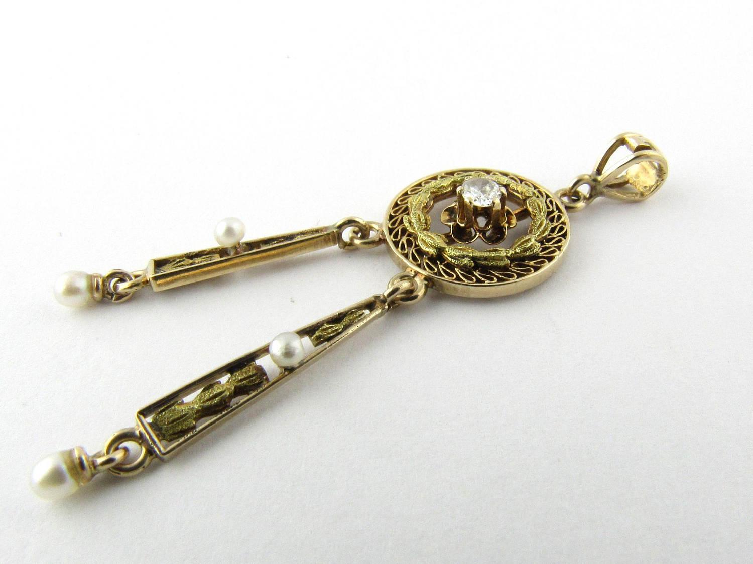 Antique Victorian 10K Yellow Gold Seed Pearl and Diamond Pendant. 

This pendant is a timeless treasure. 

This pendant measures approx 10 mm x 2 mm x 32 mm. 

This pendant hangs 39 mm from top of loop. 

1 European cut diamond approx .07 carat VS2,