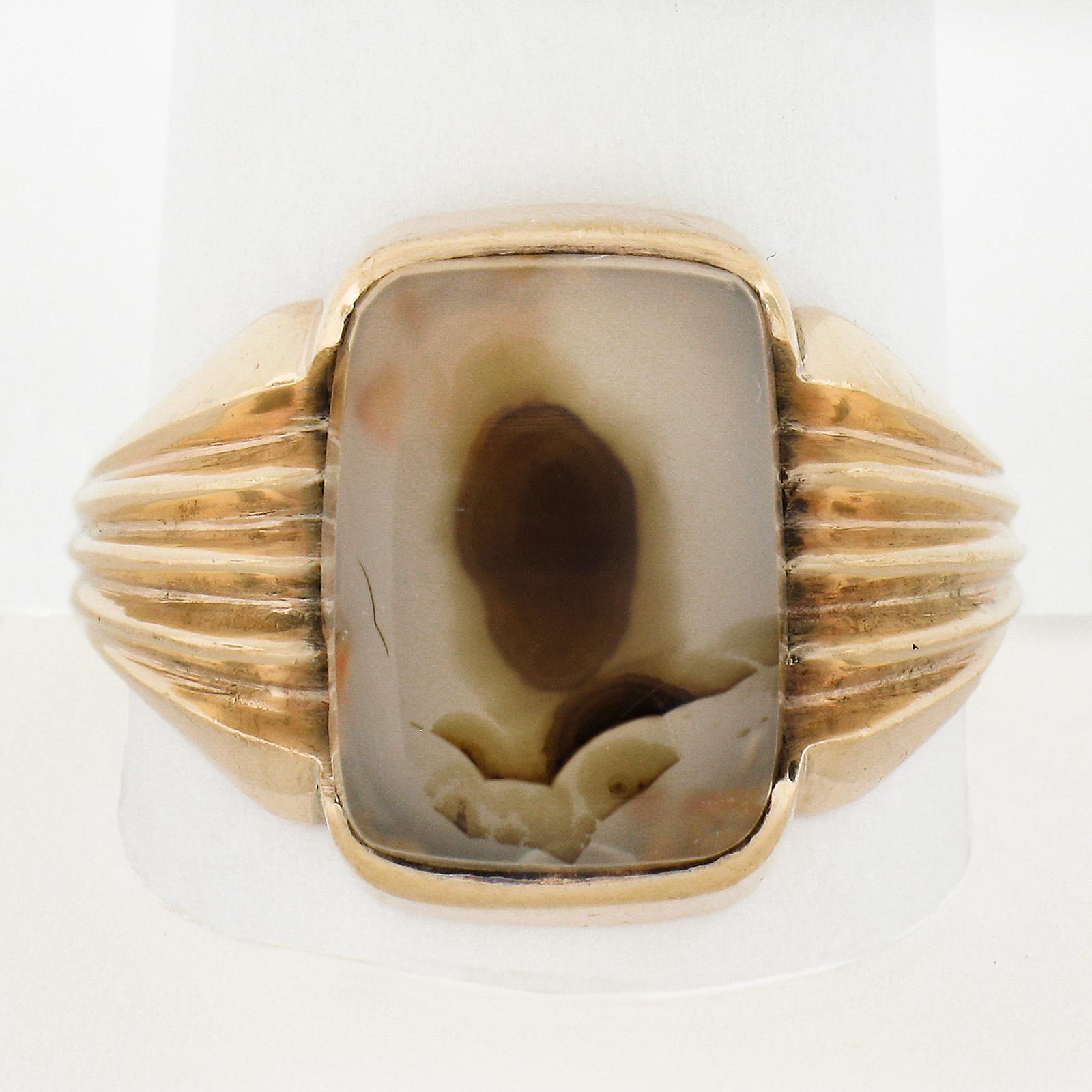 --Stone(s):--
(1) Natural Genuine Moss Agate - Rectangular Cut - Channel Set - Transparent with Brown Color - 14.3x10.5mm (approx.)

Material: Solid 10k Rosy Yellow Gold
Weight: 8.58 Grams
Ring Size: 11 (Fitted on a finger. We can custom size this