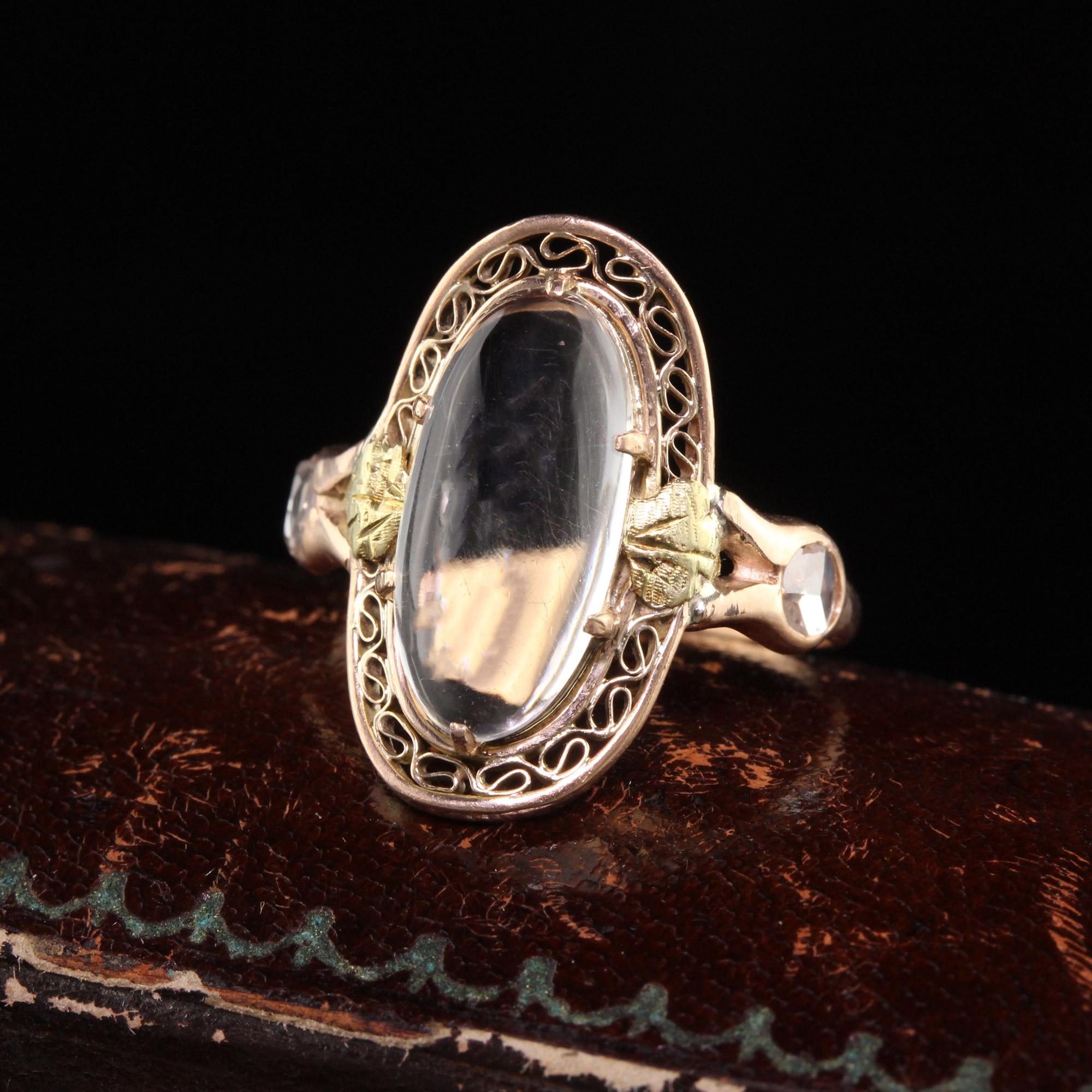 Beautiful Antique Victorian 10K Rose Gold and Yellow Gold Moonstone Rose Cut Diamond Ring. This beautiful ring is crafted in 10k rose gold and yellow gold accents. The ring has a nice moonstone on the top with two white rose cut diamonds on the