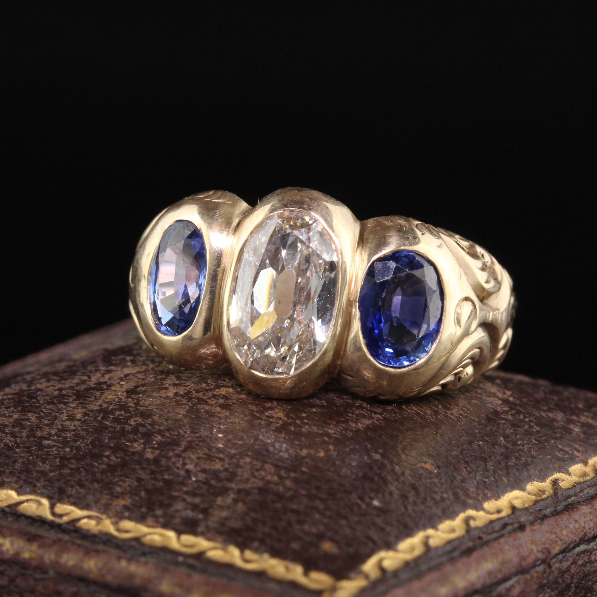 Beautiful Antique Victorian 10K Yellow Gold Old Cut Diamond Sapphire Three Stone Ring. This gorgeous three stone ring is crafted in 10K yellow gold. The center diamond is an old cut oval and the sides are natural blue sapphires in a gorgeous