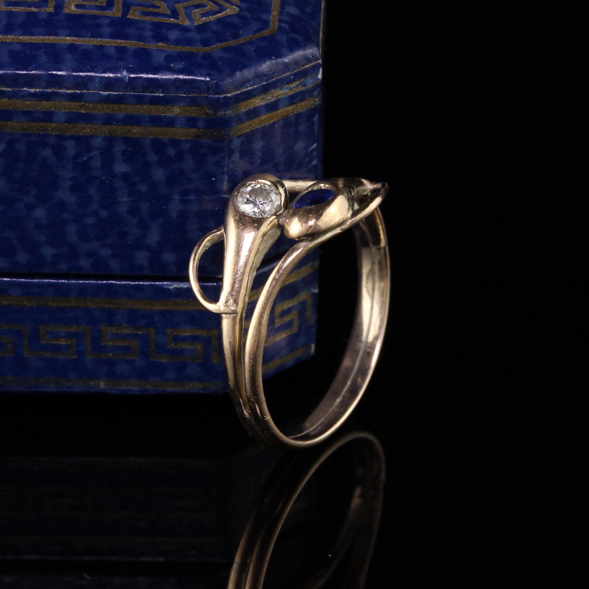 Beautiful Antique Victorian 12K Yellow Gold Diamond and Sapphire Double Snake Ring. This ring features and old european cut diamond and an old cut sapphire in the head of the snakes. It is handcrafted and sits comfortably on the finger.

Item