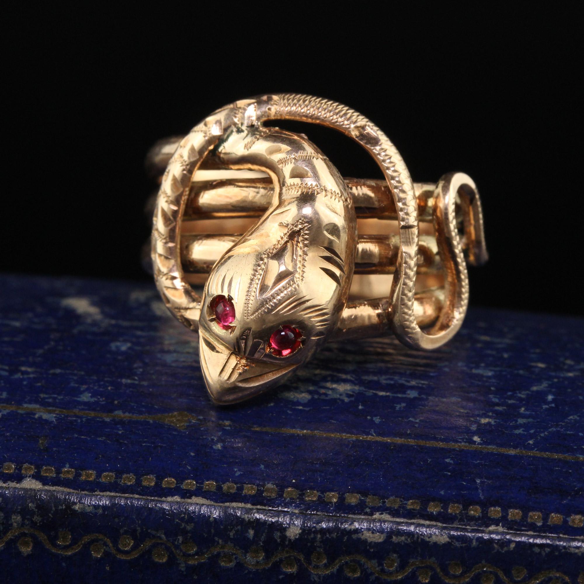 Beautiful Antique Victorian 12K Yellow Gold Wide Snake Ring - Size 8 1/4. This beautiful snake ring is crafted in 12k yellow gold. The ring has a coiled snake and the top is engraved nicely with two ruby eyes. The ring is in good condition and sits
