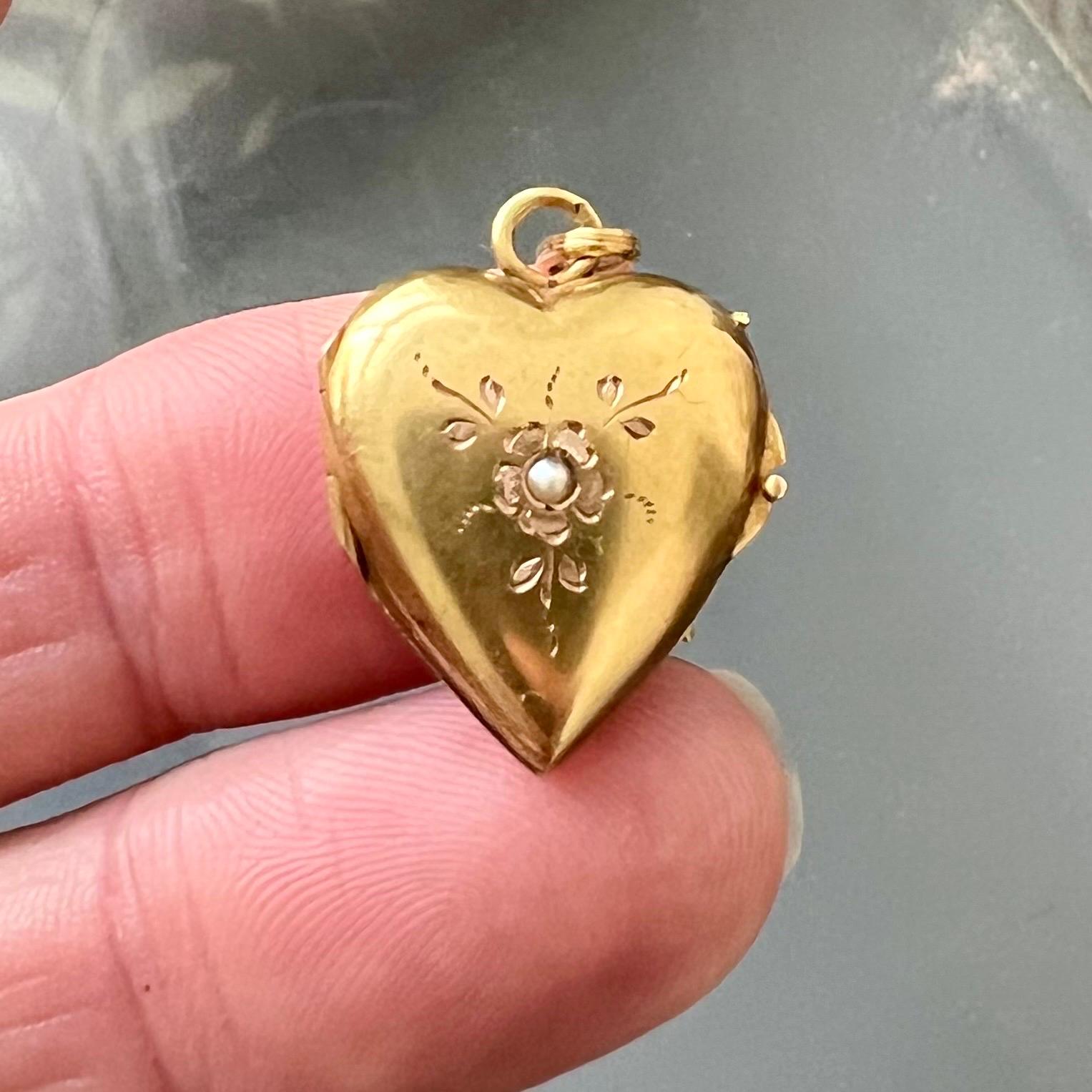 This exquisite 14-karat gold heart-shaped locket pendant from the 19th century is a stunning example of antique Victorian craftsmanship. The pendant is beautifully shaped into a delicate heart, symbolizing love and affection, and is adorned with an