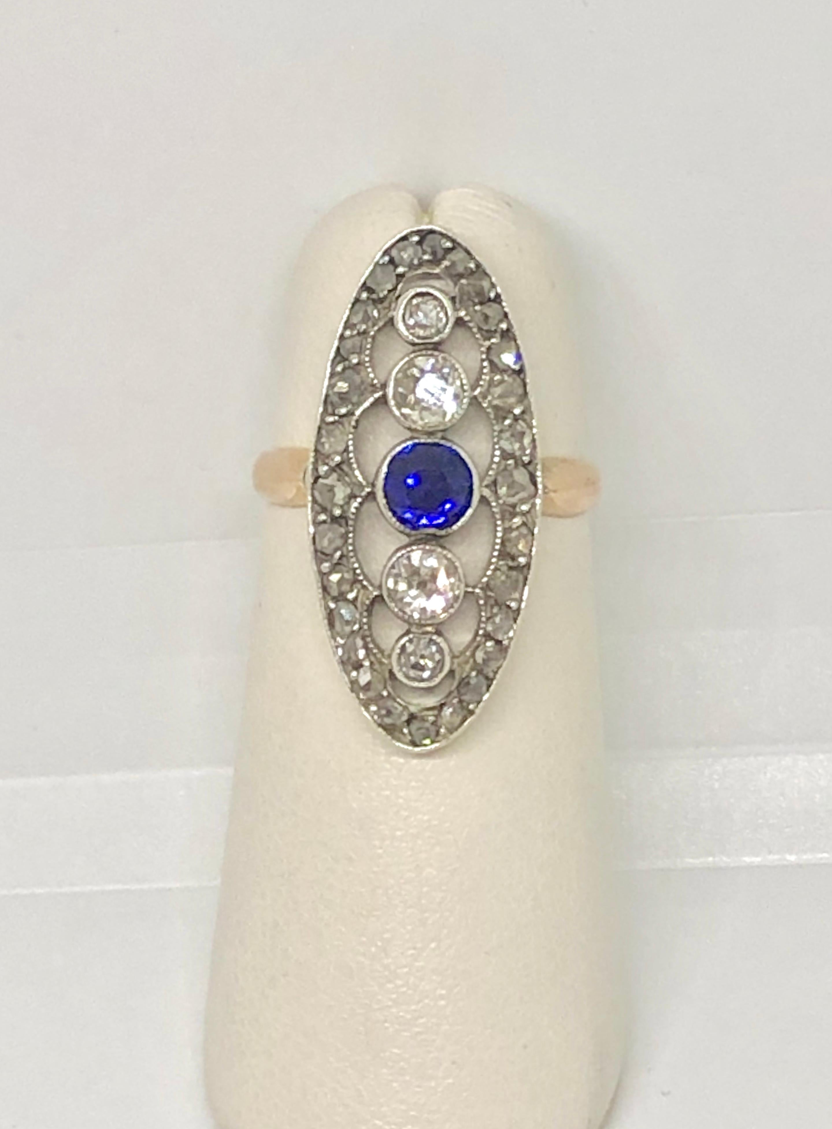 Antique Victorian 14 Karat Rose Gold Diamond and Sapphire Dinner Ring. This true antique piece is one of a kind. Created in 14 karat rose gold shank and sterling shield top. Weight = 3.3 grams, 2 DWT. One 4 mm round Sapphire center=.32 carat approx.