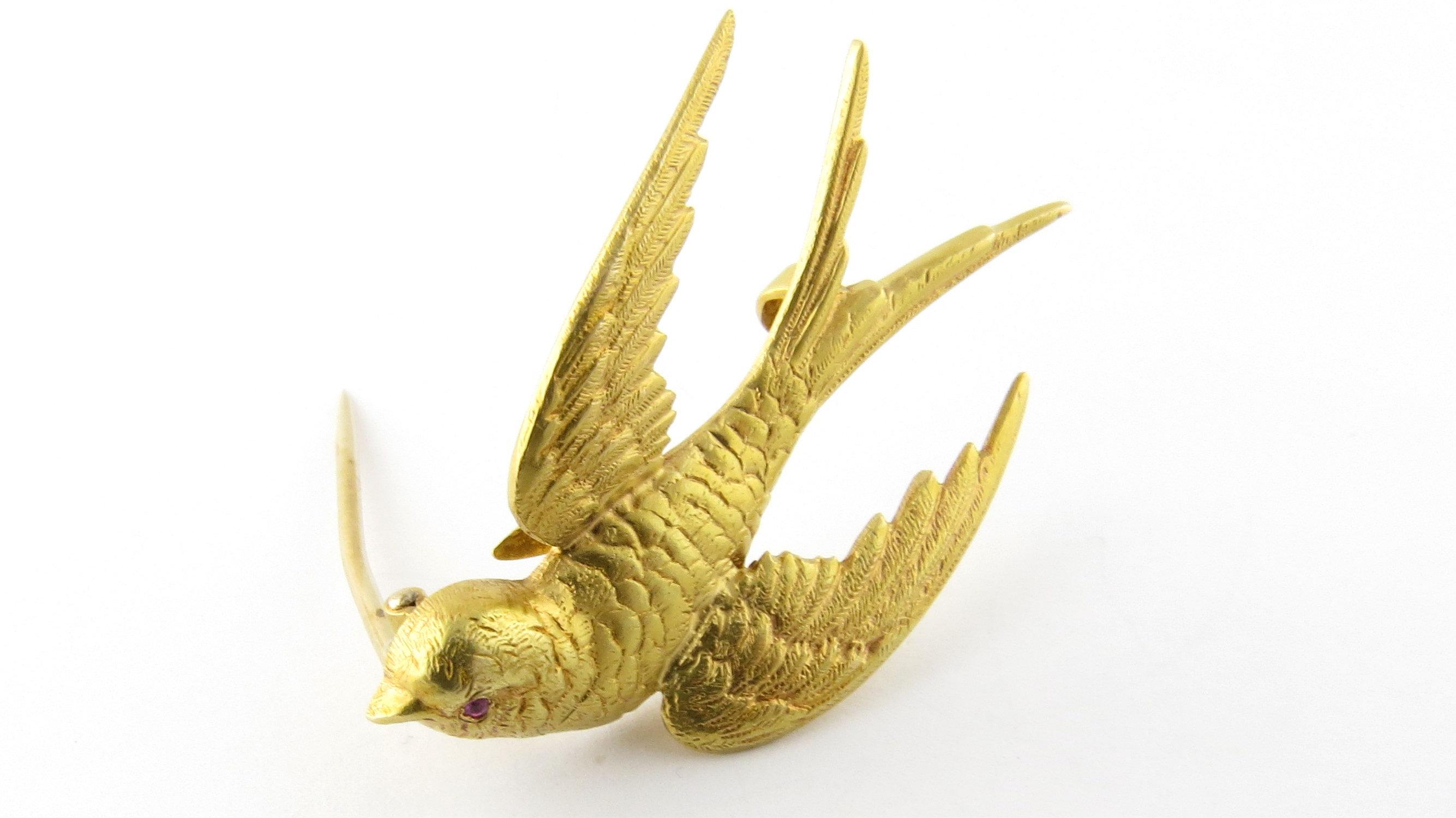 Antique Victorian 14 Karat Yellow Gold and Ruby Barn Swallow Brooch-

This lovely brooch was produced by The Riker Brothers Firm, an American jewelry company in the early 1900's who were known for their bird pendants and brooches. This piece depicts