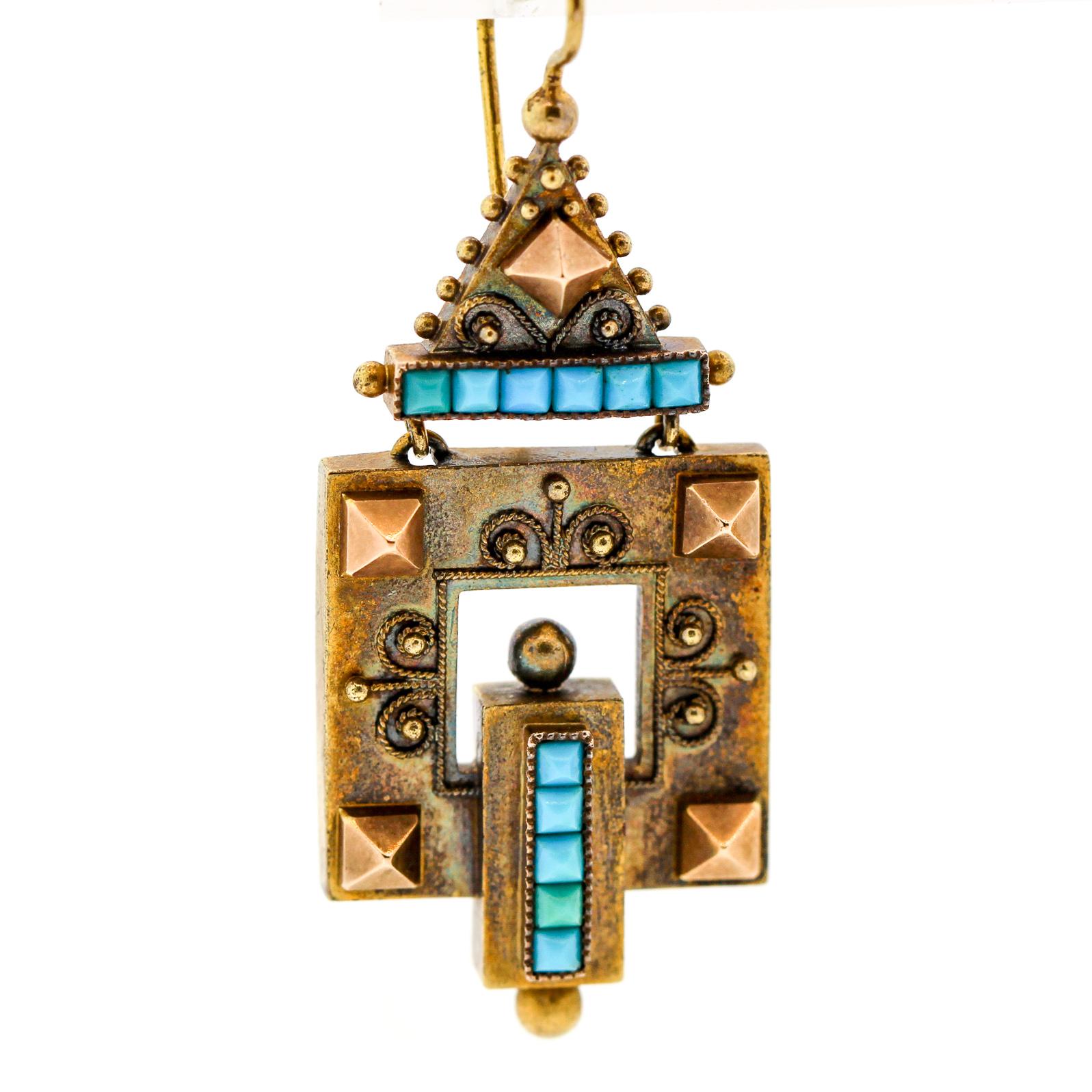 A pair of antique Victorian 14k yellow gold and buff top turquoise geometric pendant earrings. These earrings are wonderfully modern in feel with gold canetille work and rivet like details. The buff top turquoise is a marvel to behold. The earrings