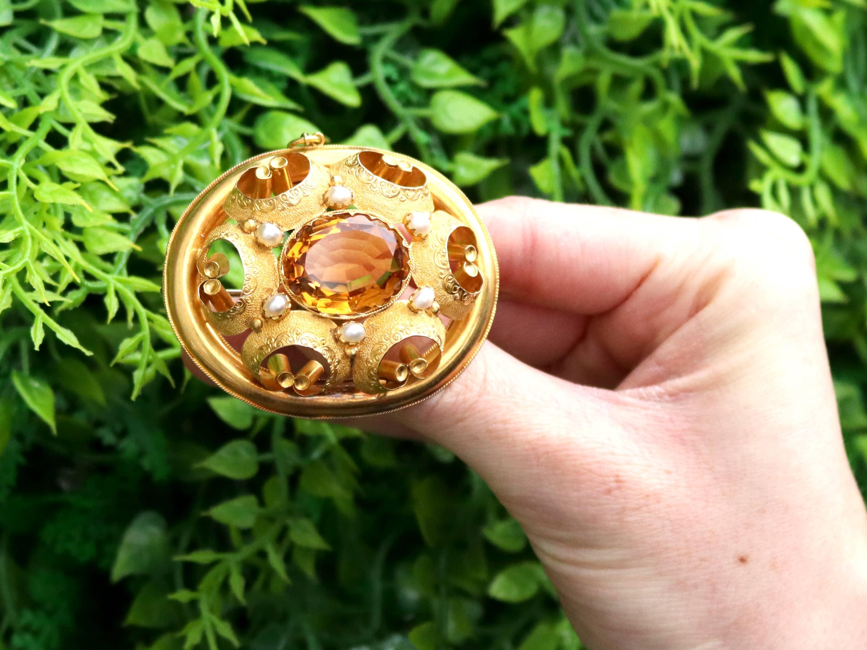 A stunning, fine and impressive, large antique Victorian 14.32 carat citrine and natural pearl, 20 karat yellow gold brooch; part of our diverse antique jewelry and estate jewelry collections

This stunning and large Victorian brooch has been
