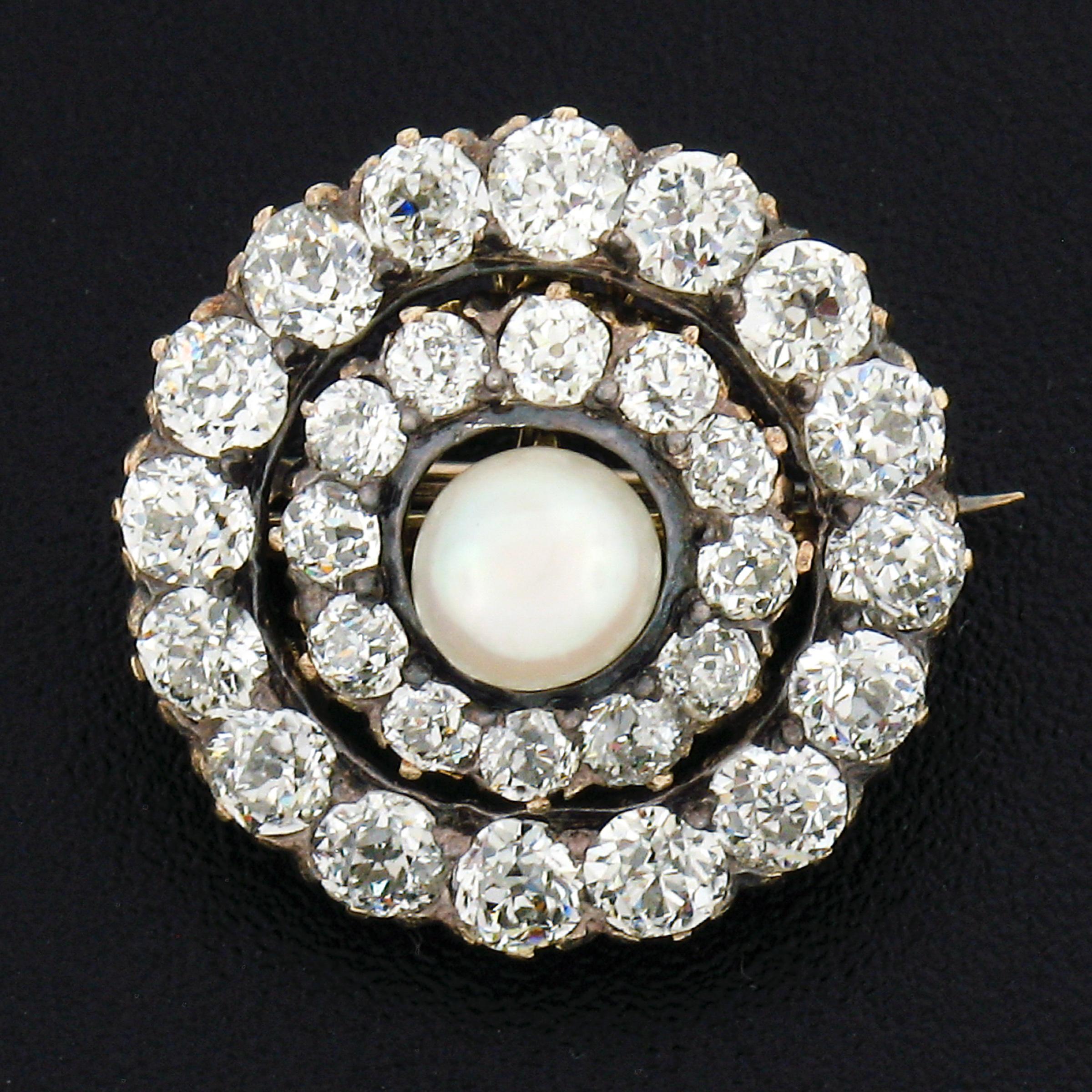 This unique antique pin/brooch or pendant was crafted during the early Victorian period in solid 14k gold and features a wonderful dual circular design that is elegantly covered with old mine and European cut diamonds throughout. The center of the