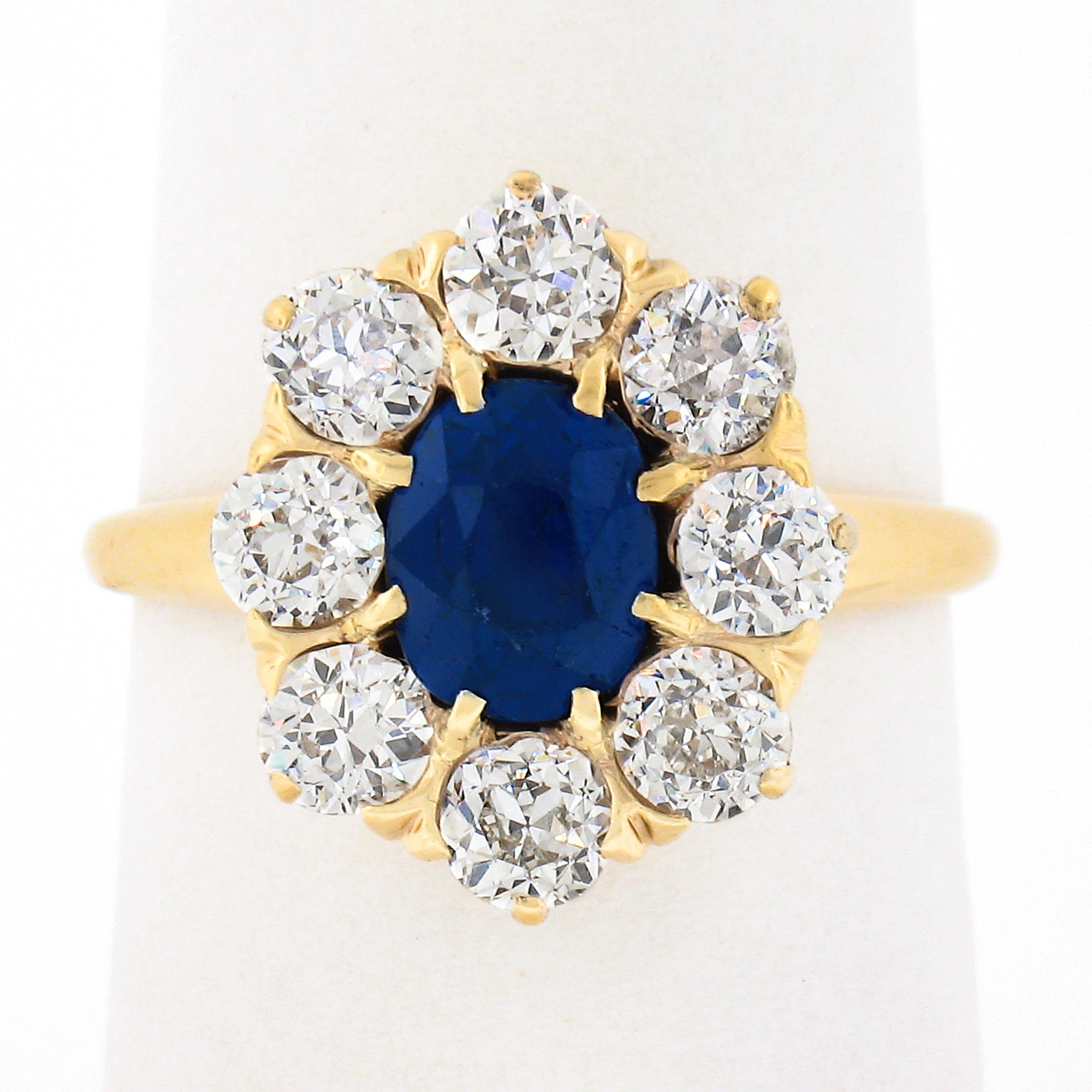 You are looking at a truly breathtaking antique sapphire and diamond engagement ring that was crafted during the Victorian period from solid 14k yellow gold. The ring features a gorgeous, old oval cut, Burma sapphire stone that is elegantly