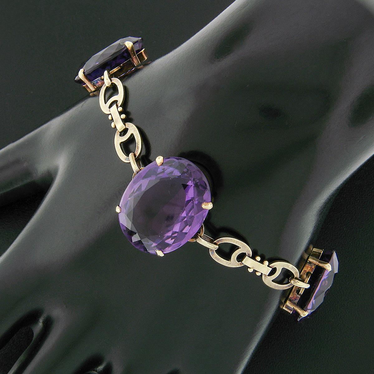 This outstanding antique amethyst bracelet was crafted from solid 14k yellow gold during the Victorian era. It features 3 large oval cut natural amethysts totaling approximately 37.08 carats in weight which display a magnificent and well-matched