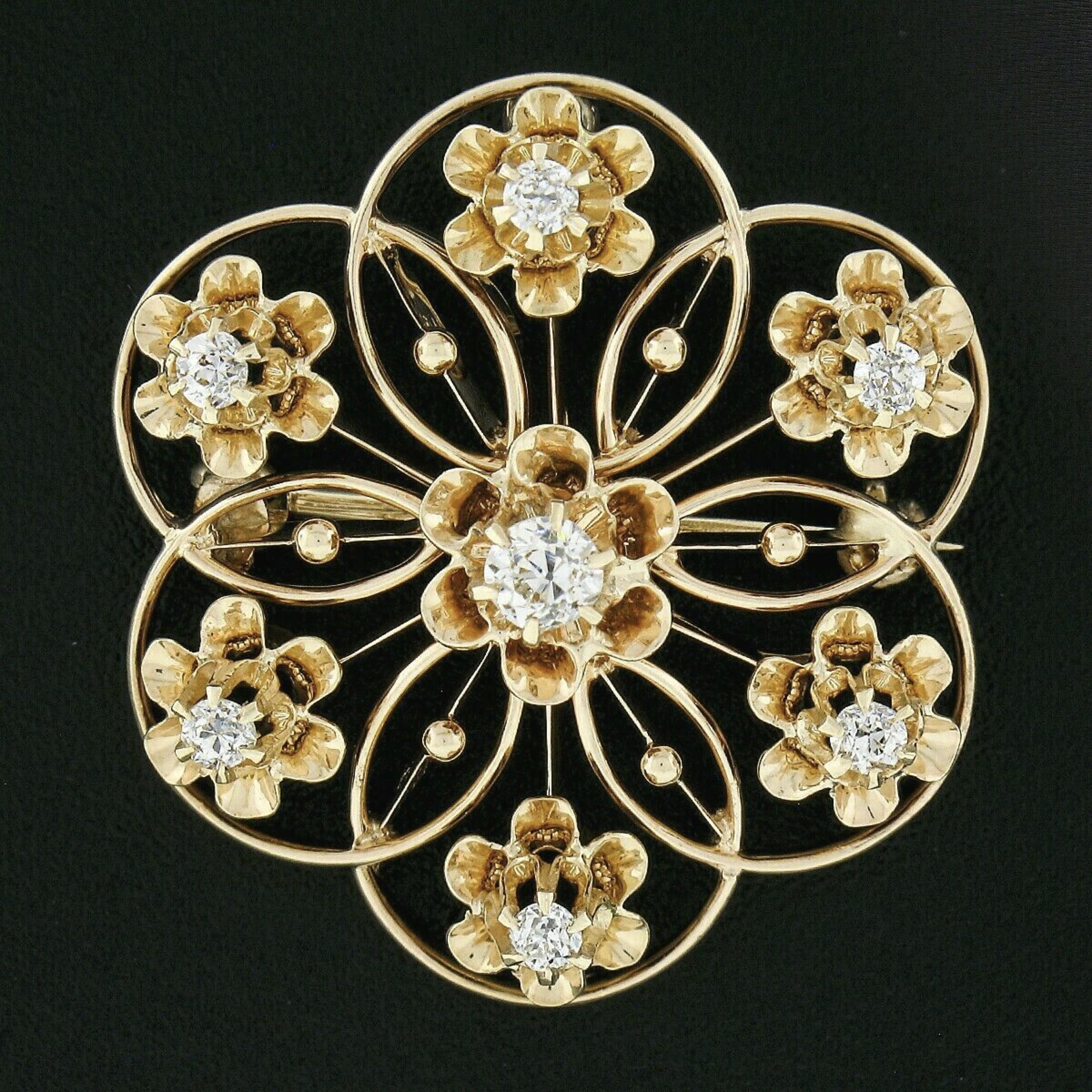 This gorgeous antique brooch or pendant was crafted in solid 14k yellow gold during the late Victorian era and features a gorgeous open work flower design that is set with 7 old European cut diamonds throughout. These stunning diamonds are elegantly