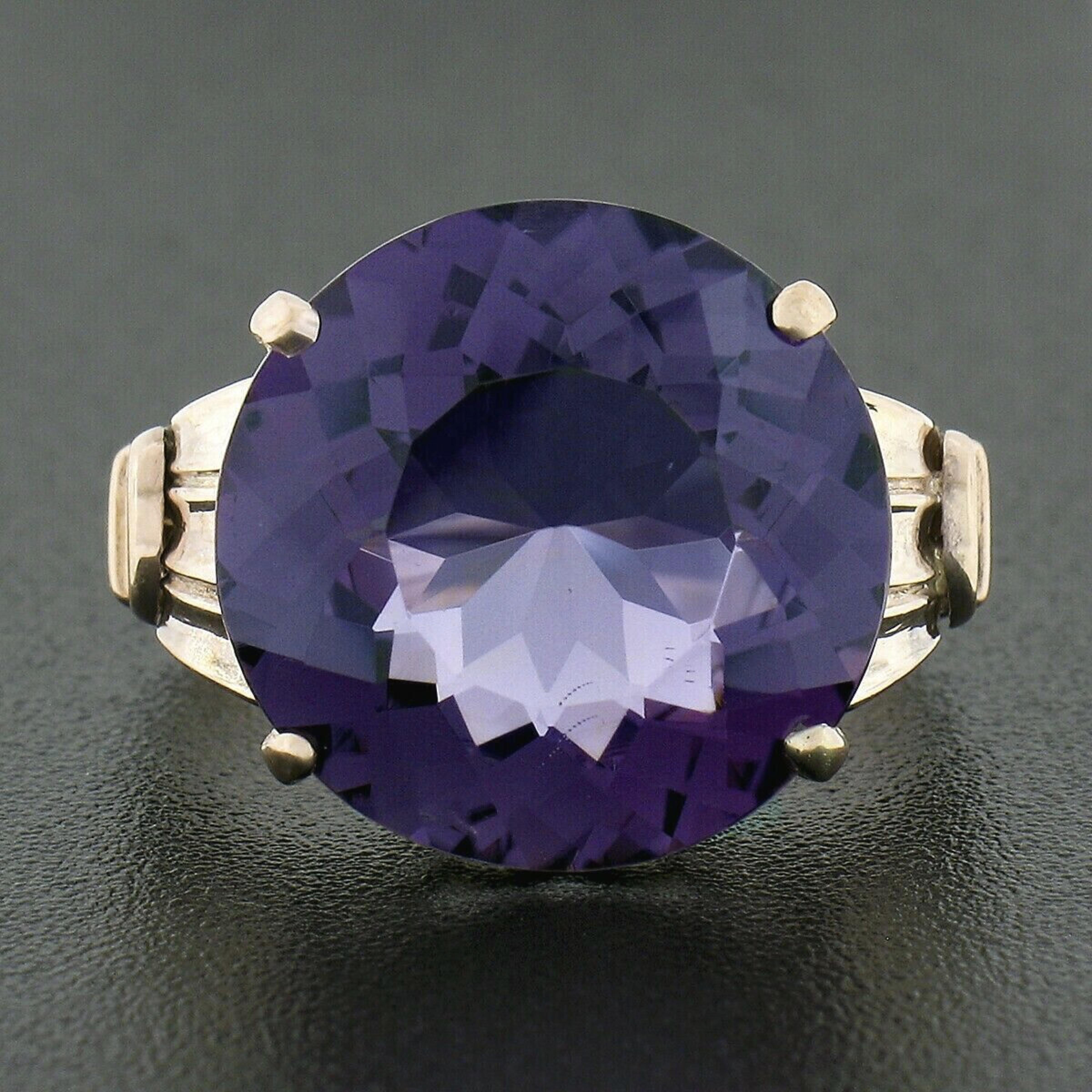 Here we have a stunning antique solitaire ring that was crafted during the Victorian era from solid 14k gold. It features a fine round brilliant cut amethyst that shows a large size, weighing approximately 8.75 carats, and displays a truly gorgeous