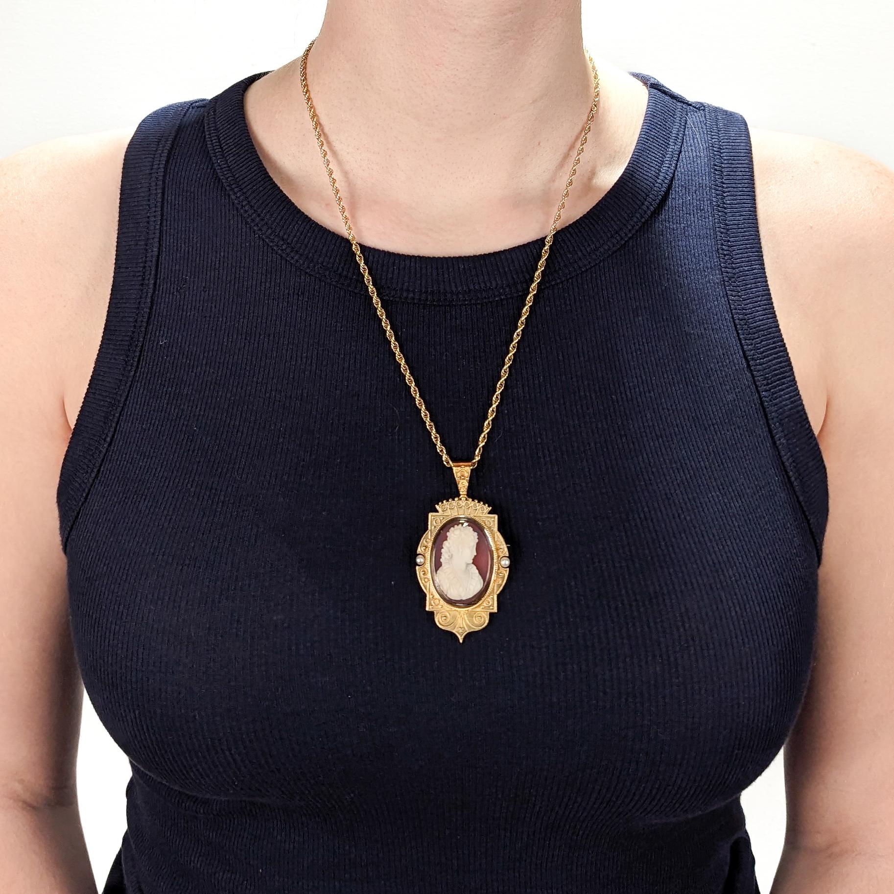 A fine antique Victorian convertible brooch / pendant for a necklace.

In 14k gold.

Comprising a cameo brooch with a oval reserve for a photo to the reverse and a tapered bail. 

Centered on a pink and white carved agate or hard stone cameo of a