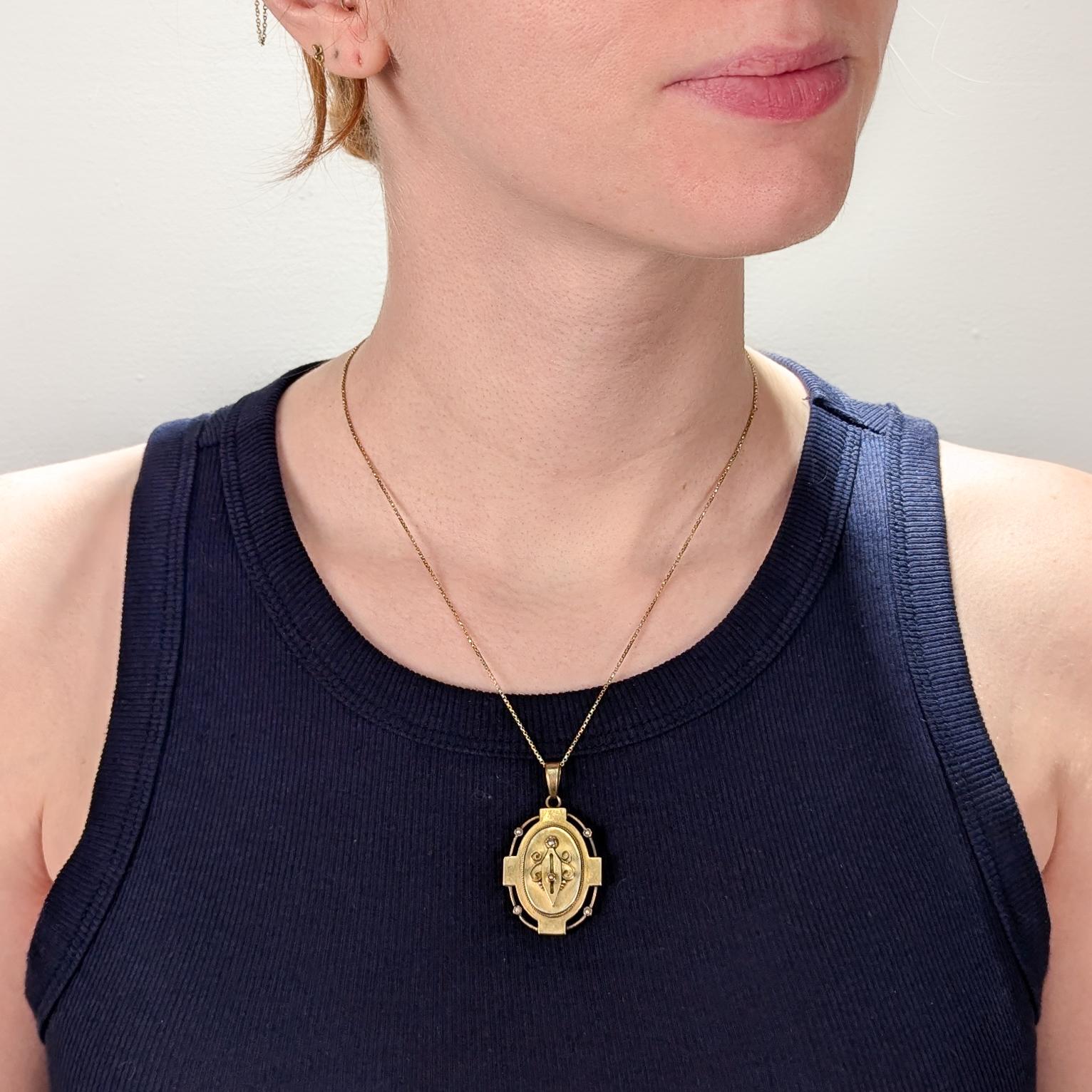 A fine antique Victorian locket for a necklace.

In 14k yellow gold.

With wire work decoration, granulation and bezel-set seed pearls throughout.

The reverse with a engraved, hinged cover that opens to reveal a 2 glazed compartments for pictures
