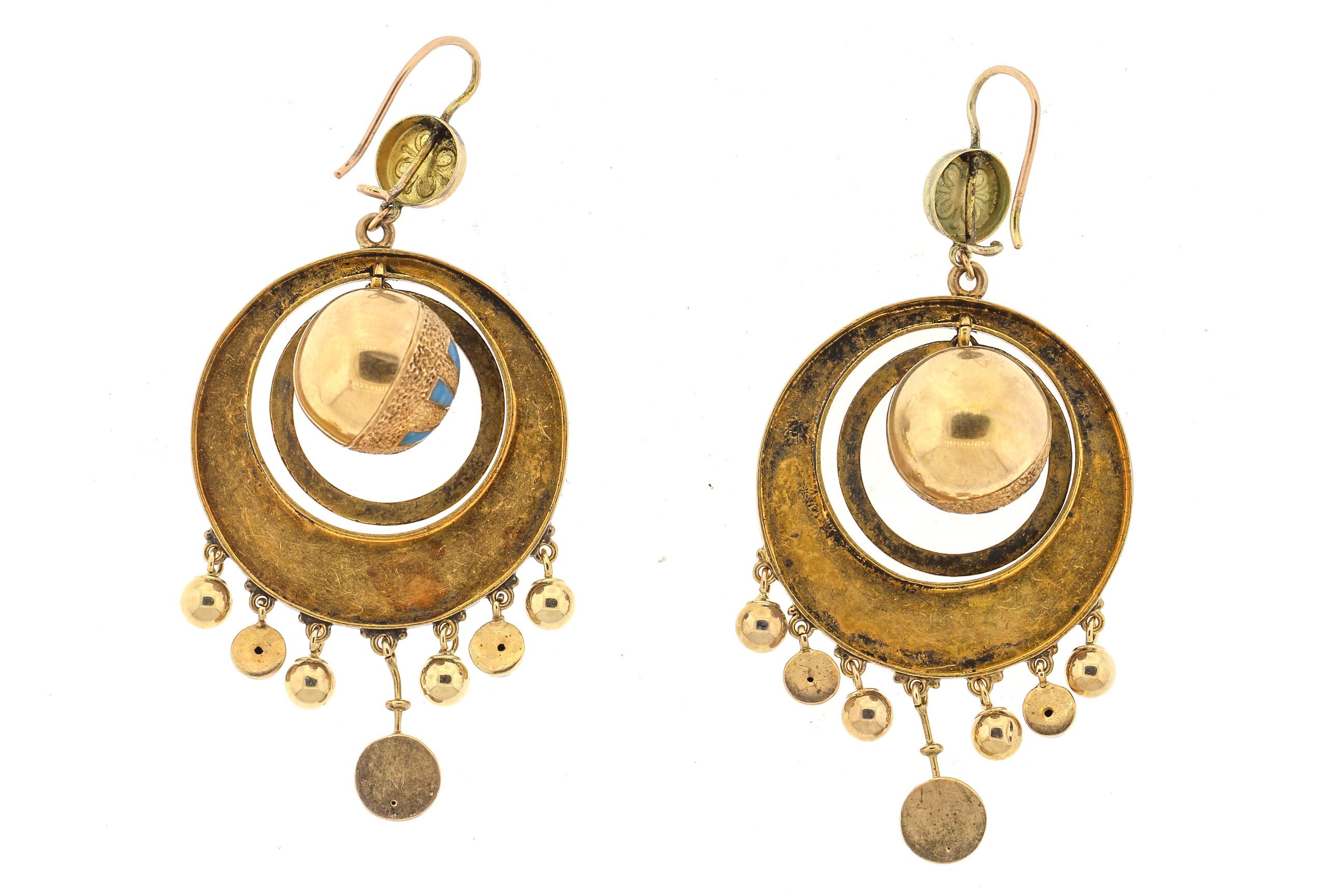 A swingy pair of Victorian 14k gold blue enamel drop earrings. These earrings are several moving circles surrounding a ball with fringe dangles on the outer circle. Quite a design of fun moving earrings. The blue enamel accents only add to these