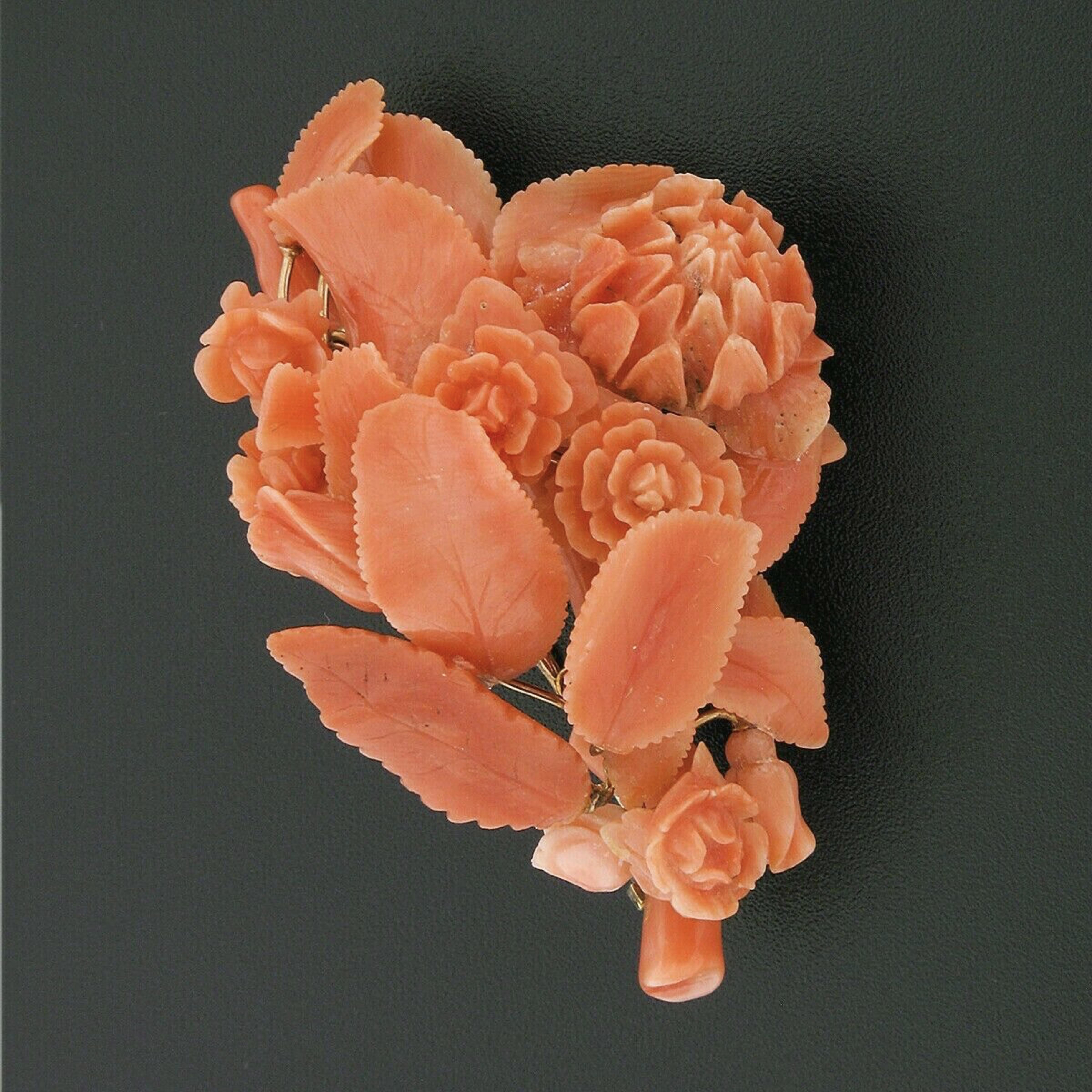 Here we have a magnificent, antique, large pin brooch that was crafted during the Victorian era and features fine coral stones in which have been masterfully carved into a truly amazing floral design. The rose flowers and leaves have been carved