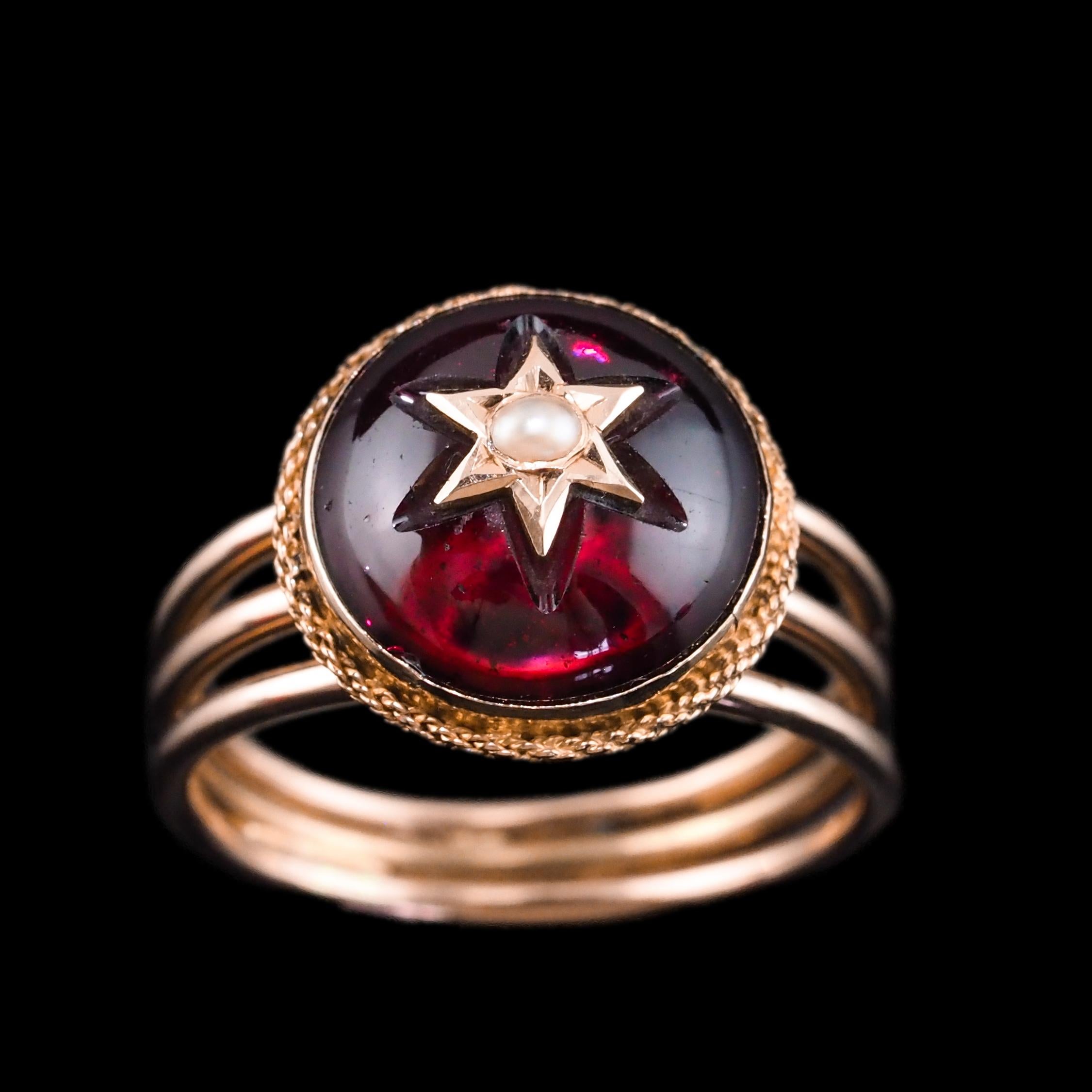 We are delighted to offer this exquisite antique Victorian garnet cabochon and seed pearl star ring made c.1880.
 
Unapologetically Victorian, this ring features some of the most desirable and stylish elements of the period. A celestial theme/style