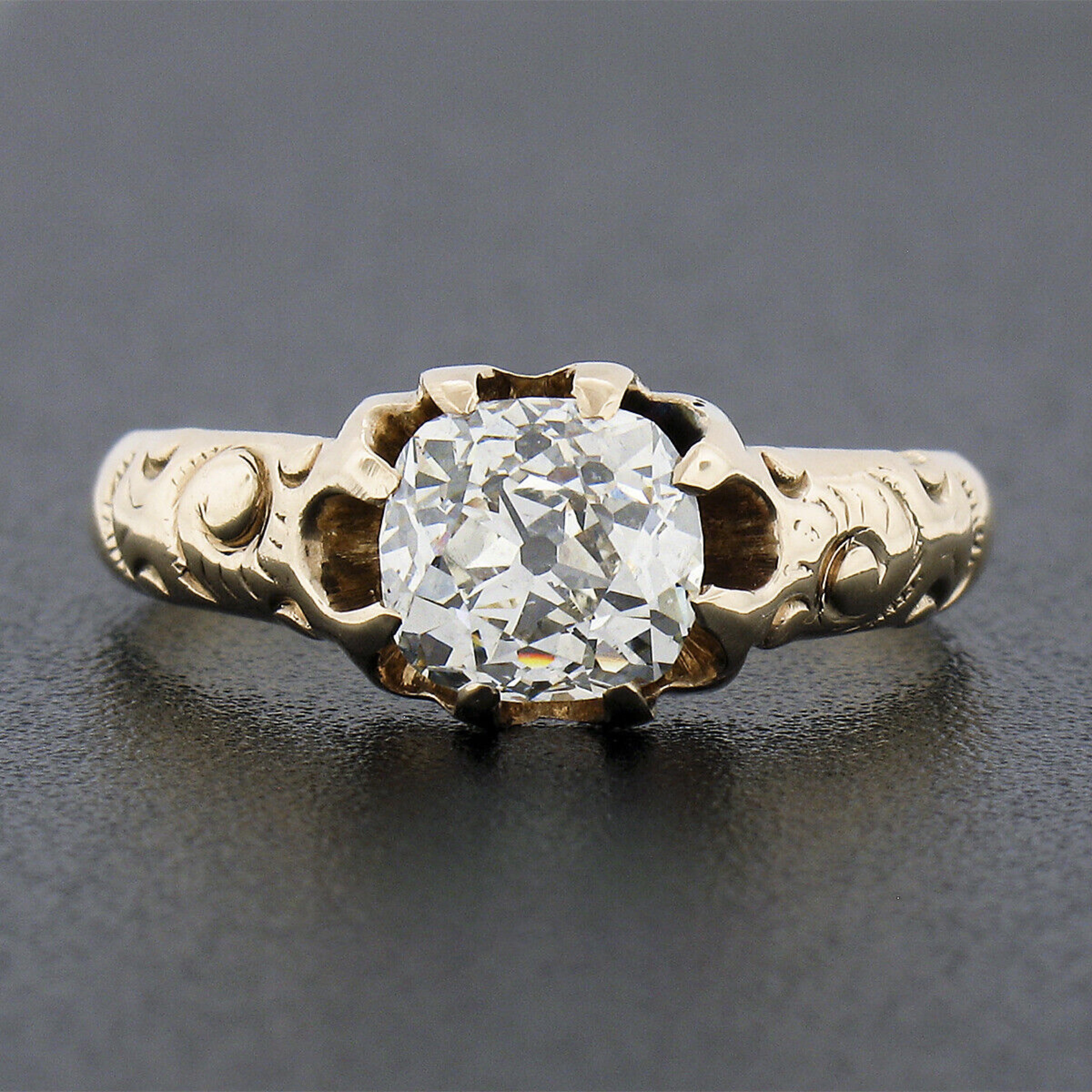 This stunning antique ring was crafted from solid 14k yellow gold during the Victorian era and features a truly breathtaking old mine cushion cut diamond solitaire at its center. This fine quality diamond is GIA certified at exactly 1.20 carats and