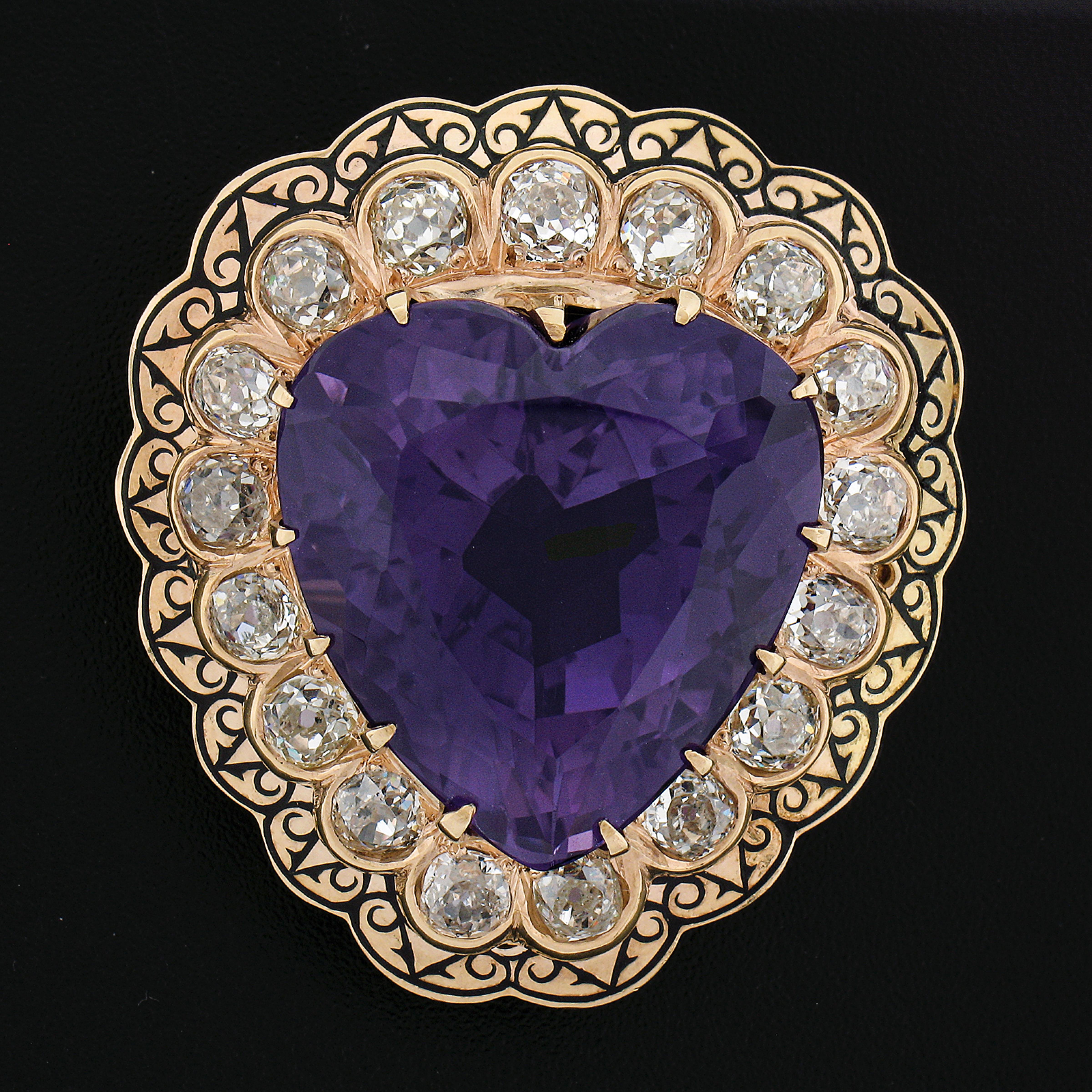 This impressive antique brooch or pendant was crafted during the Victorian ear in solid 14k yellow gold and features a large heart design that is set with a truly mesmerizing royal purple amethyst stone that is surrounded by 17 old mine cut diamonds