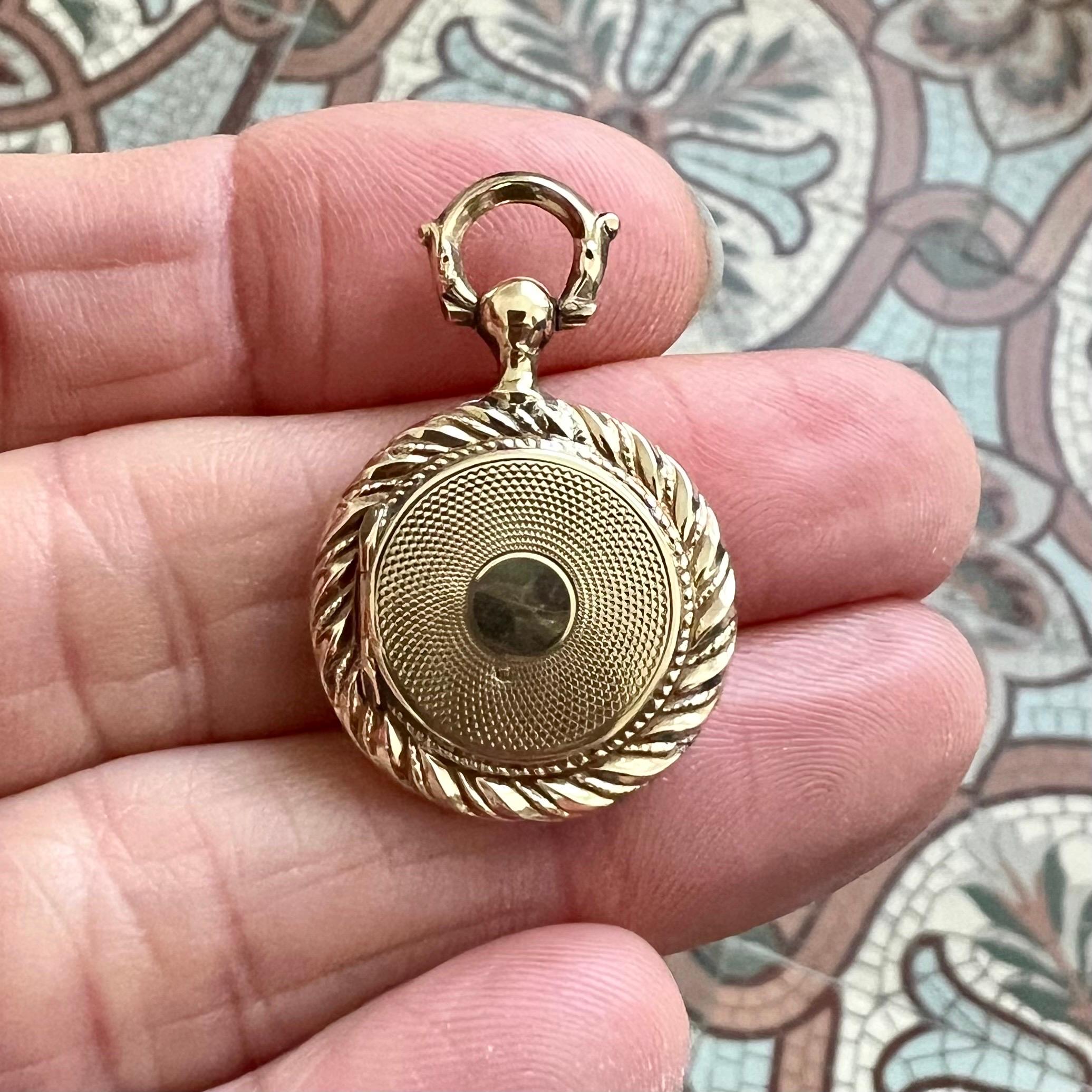 This elegant antique Victorian locket pendant, crafted in 14K gold, is a beautifully preserved piece of 19th-century jewelry. Designed to hold a cherished memento, the locket reflects the sentimental traditions of the Victorian era, where lockets