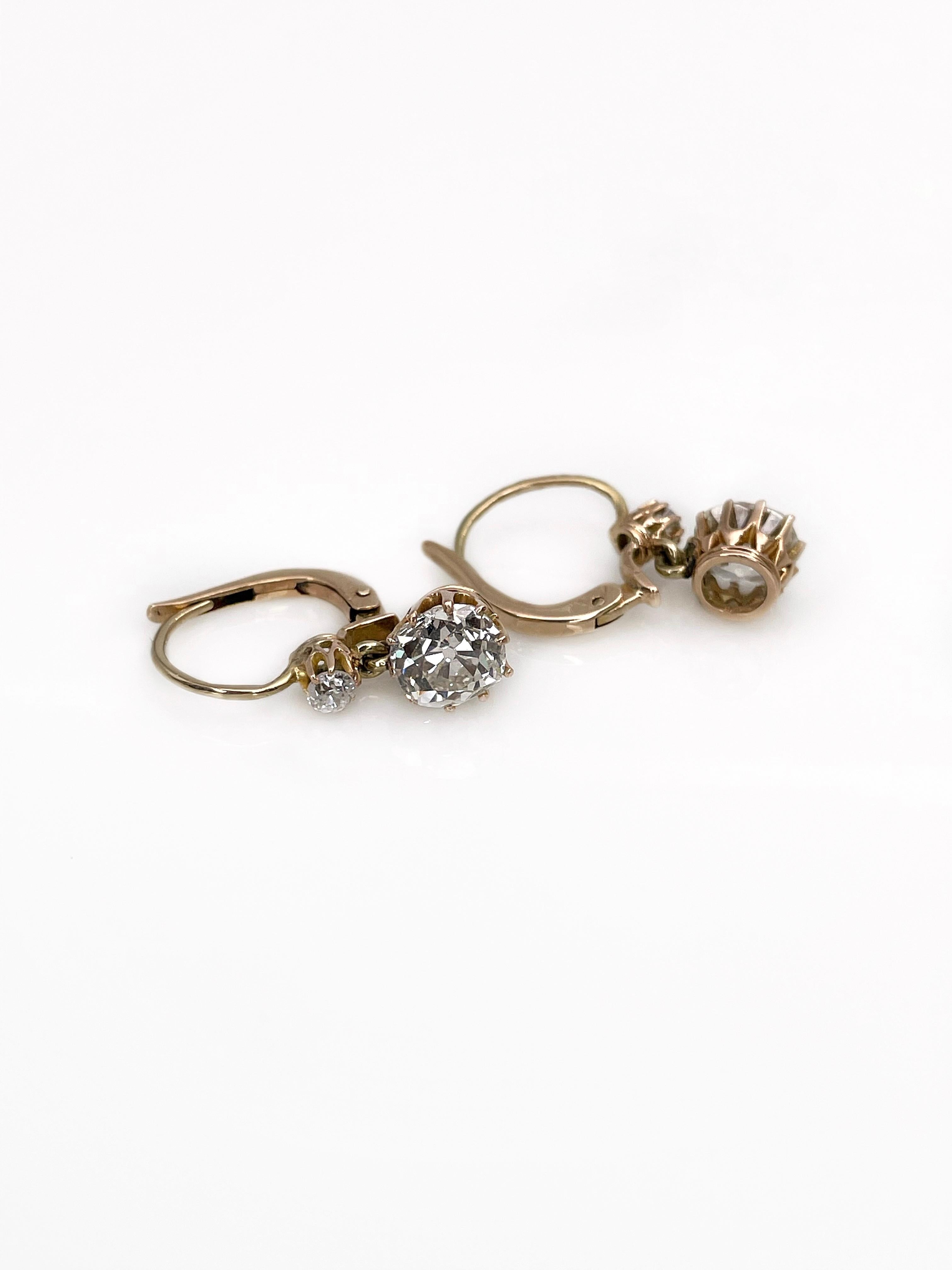 This is a gorgeous pair of lever back earrings crafted in 14K yellow gold. It features 4 round old cut diamonds which in total weight 2.30ct. The colour of the gems is W-Tinted W and the clarity - VS/SI. 

This antique piece has a dynamic design and
