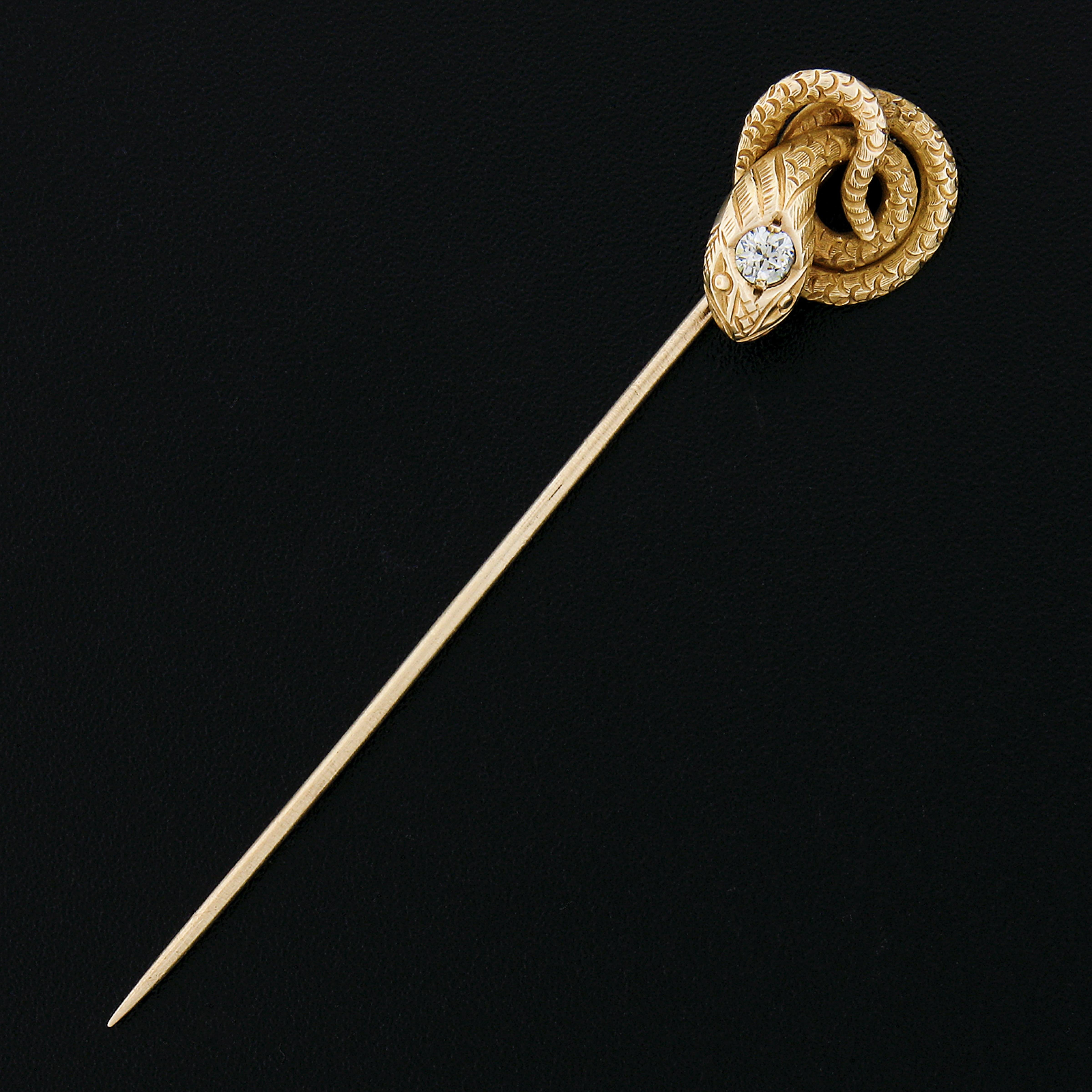 This antique stick pin was crafted during the Victorian era from solid 14k yellow gold. It displays at its top an outstanding coiled snake design showing absolutely amazing detail and texture throughout. The snake is adorned with an old European cut