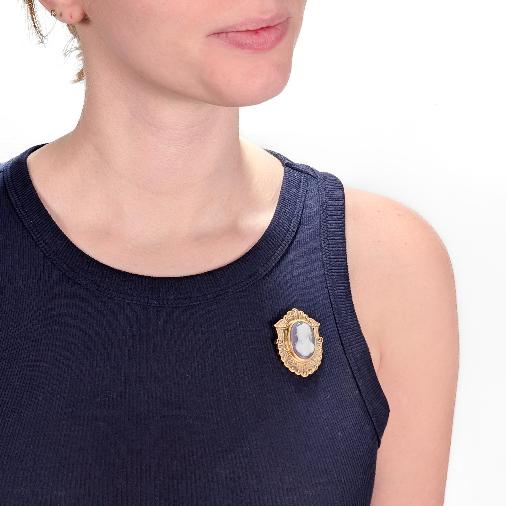 A fine antique Victorian convertible brooch.

In 14k gold.

Centered on a pink and white carved agate or hard stone cameo of a beautiful young woman with curly hair, a flowing head scarf, and a ruffled dress. 

The shaped setting with applied