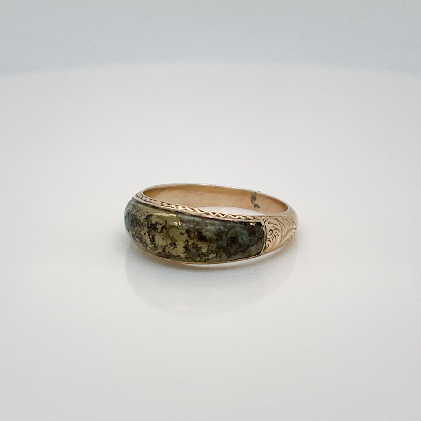 A fine antique Victorian ring.

In 14 karat yellow gold.

Inlaid with a polished, shaped pyrite (or gold quartz) cabochon and decorated with etched and engraved decoration to the sides & shoulders.

Simply a lovely pyrite specimen ring!

Date:
19th