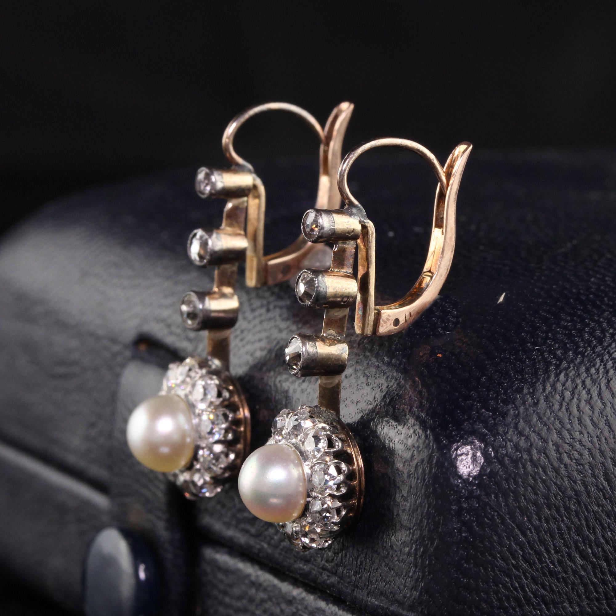 Gorgeous Antique Victorian 14K Rose Gold and Silver Top Old Mine Diamond and Pearl Earrings. This gorgeous earrings have old mine cut diamonds and natural pearls in the center of each drop. They are in great condition and ready to wear!

Item