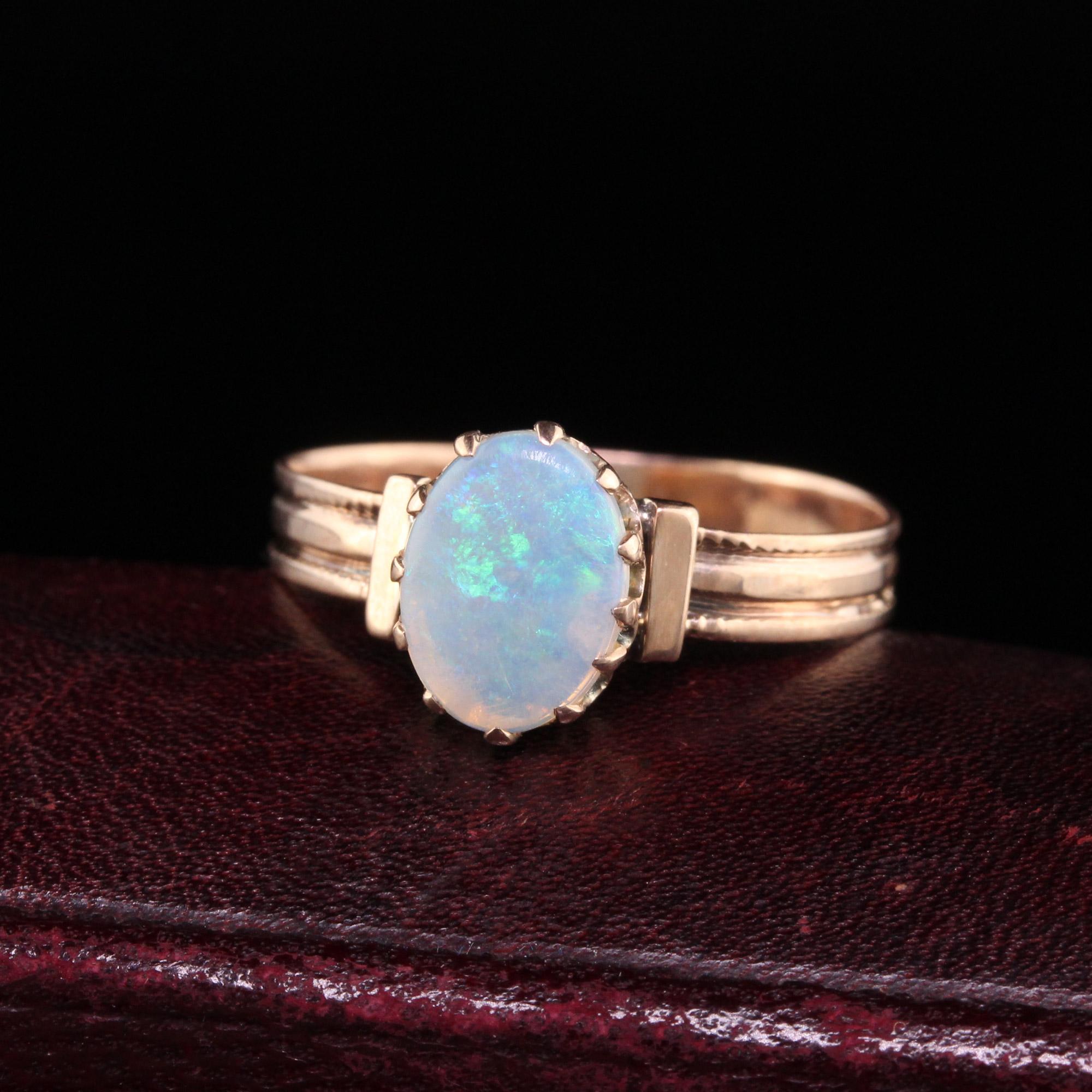 Beautiful Antique Victorian 14K Rose Gold Natural Opal Engagement Ring. This gorgeous ring is crafted in 14k rose gold. The center holds a natural opal that is translucent and shows play of color. The ring is in good condition and sits low on the