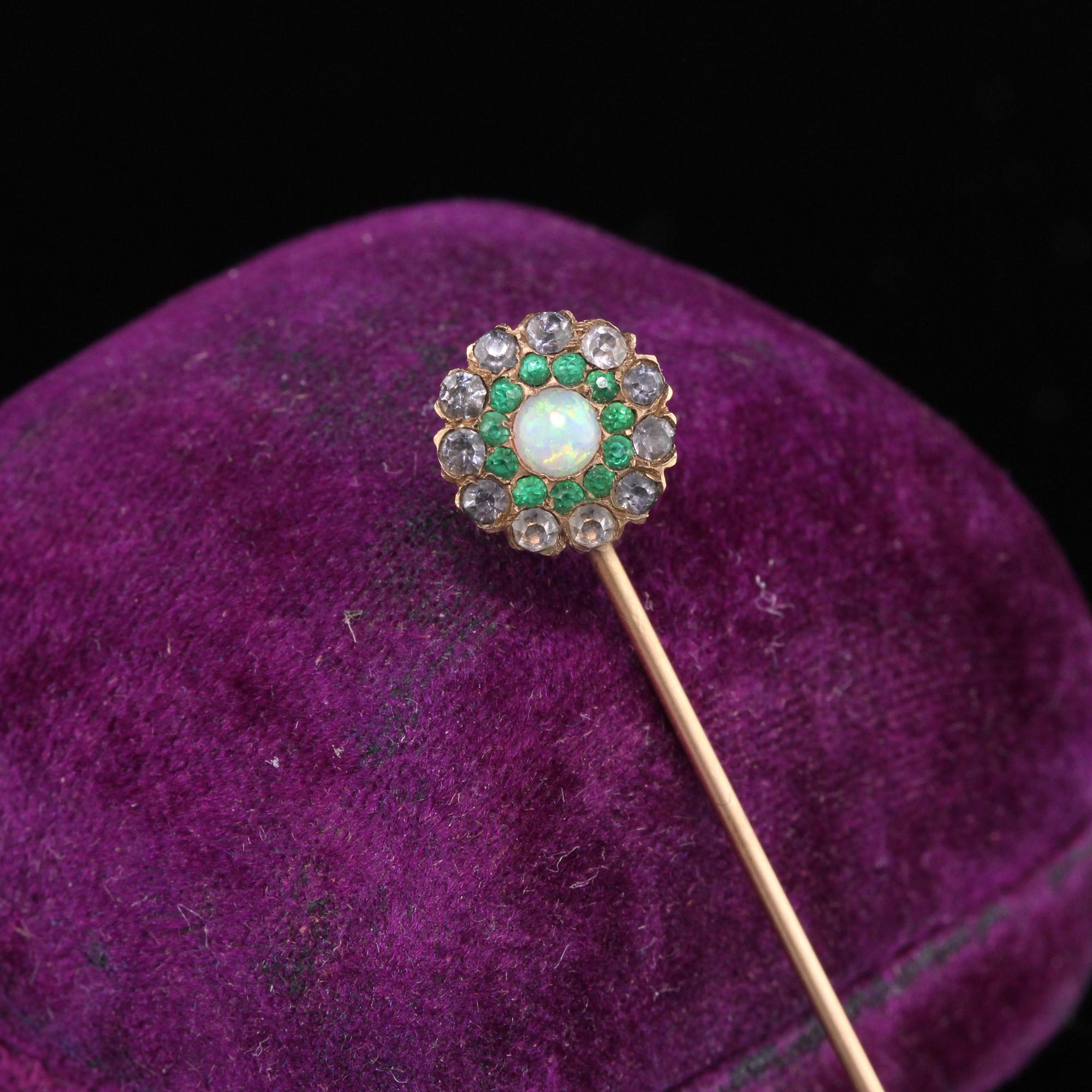 Victorian Stick Pin with an opal center surrounded by a halo of green paste and grey paste.

Metal: 14K Rose Gold 

Weight: 1.3 Grams

Measurements: Head measures 9.7 mm in circumference 
