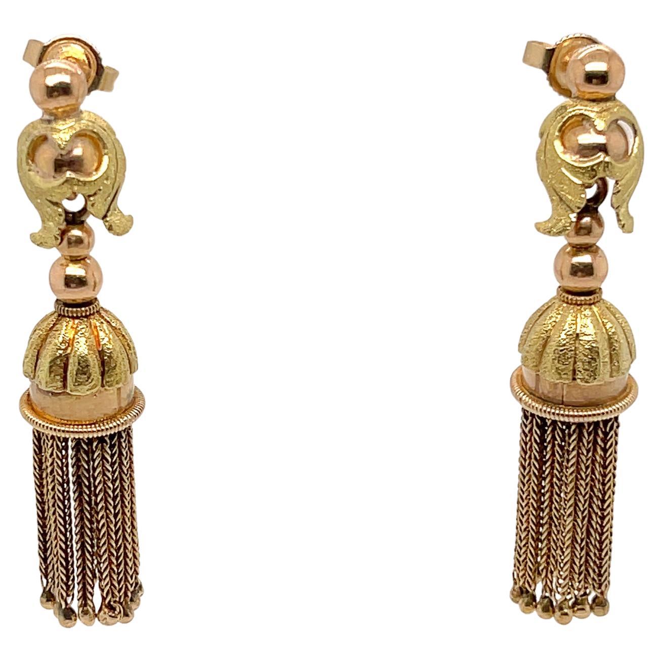 A fine pair of antique Victorian gold tassel earrings that are likely conversions.

In rose and yellow golds. 

With tassels dangling from the center of bell shaped drop and ornately engraved and textured filigree designs at the top of each post.