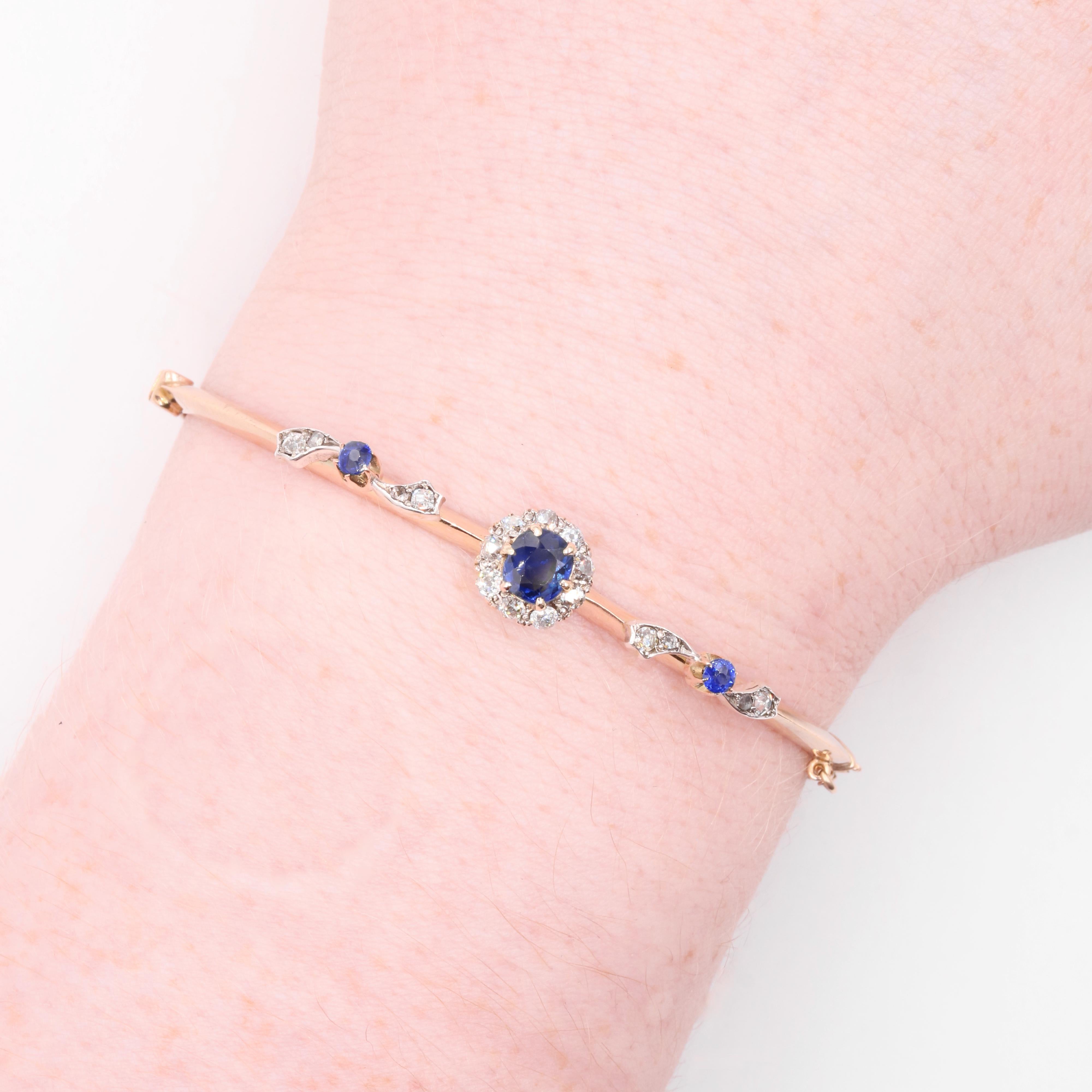A sapphire, diamond, silver, and yellow gold bangle, comprising three cushion-shaped sapphire, and seventeen old and rose cut diamonds, in silver and 14 karat yellow gold. 

My favourite thing about this Antique 14K Gold and Silver Sapphire and